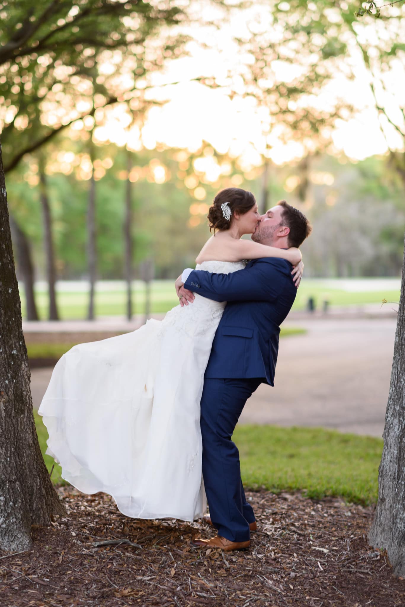 Portraits of couple in front of the clubhouse backlit by the sunset - Pawleys Plantation