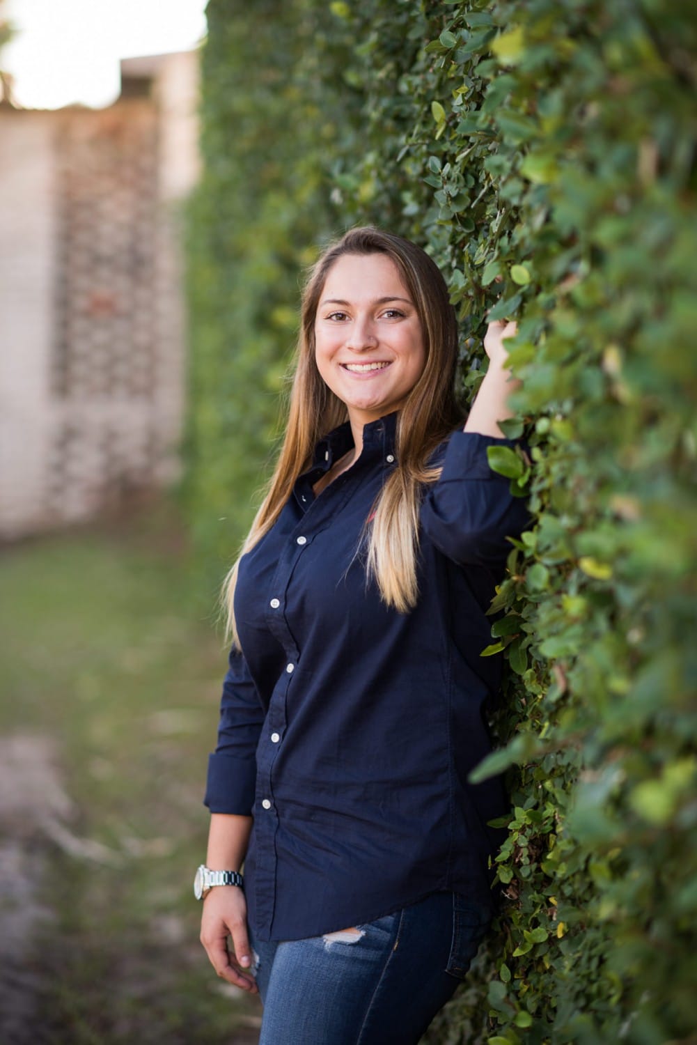 Senior portrait by the ivy covered wall - Atalaya Castle