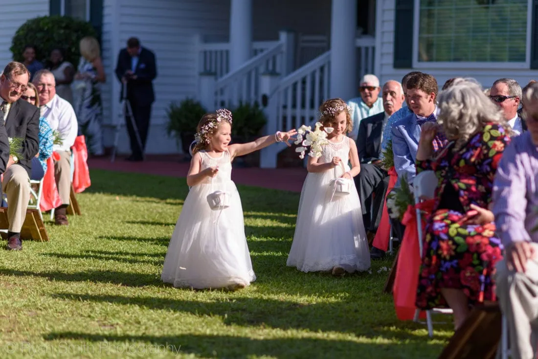 Flower girls toss petals down the aisle at Upper Mill Plantation