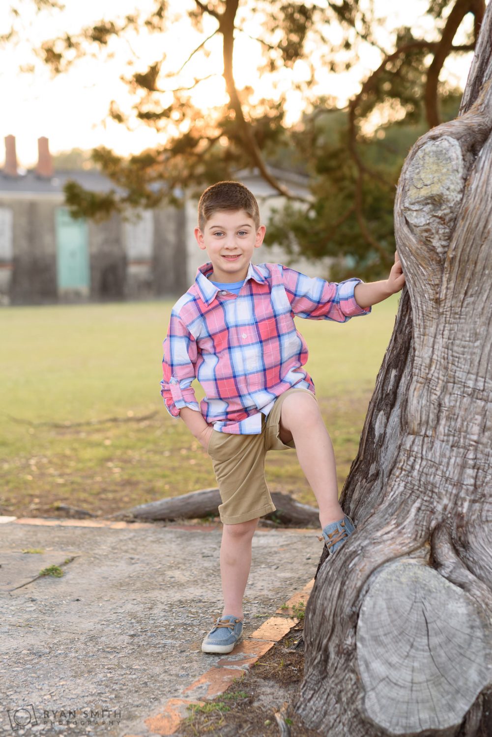 Boy leaning against tree Huntington Beach State Park
