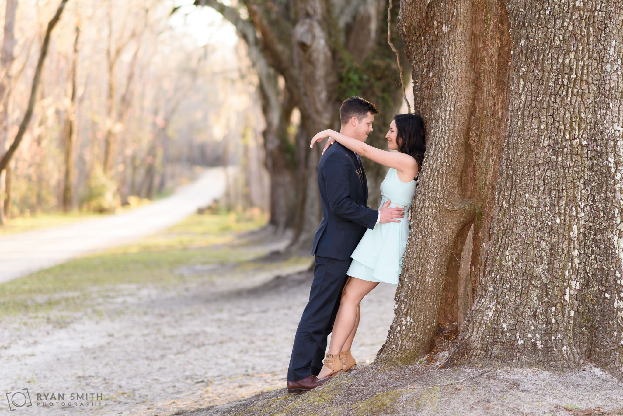 Couple leaning against a huge oak tree Mansfield Plantation, Georgetown