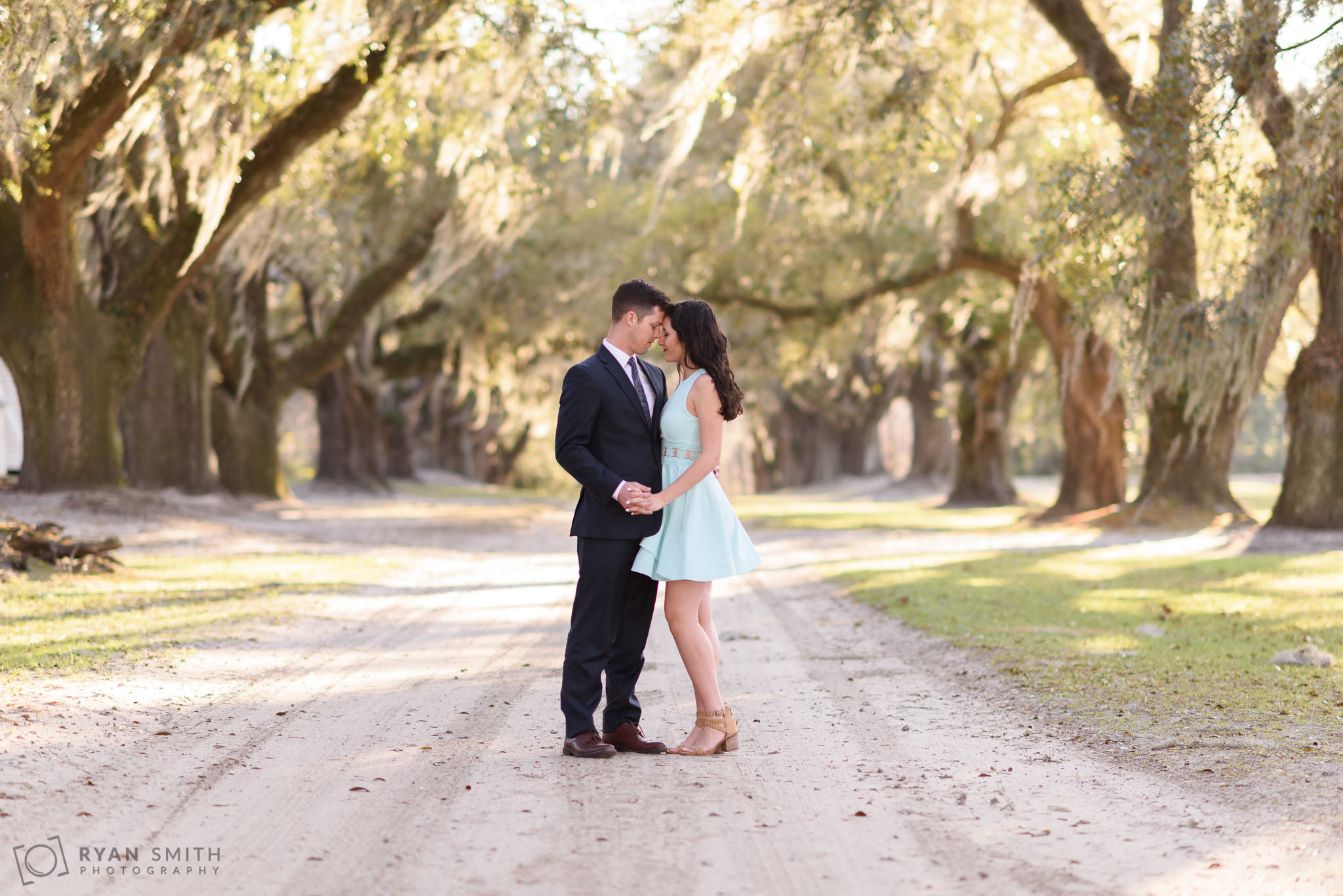 Couple touching heads under the oaks Mansfield Plantation, Georgetown