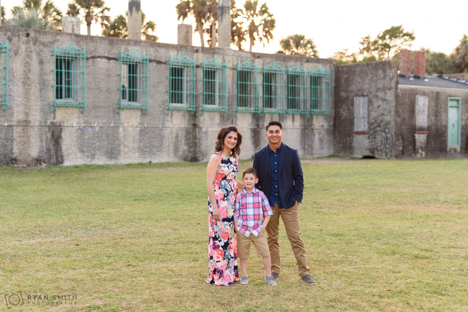 Family of three in front of the castle Huntington Beach State Park