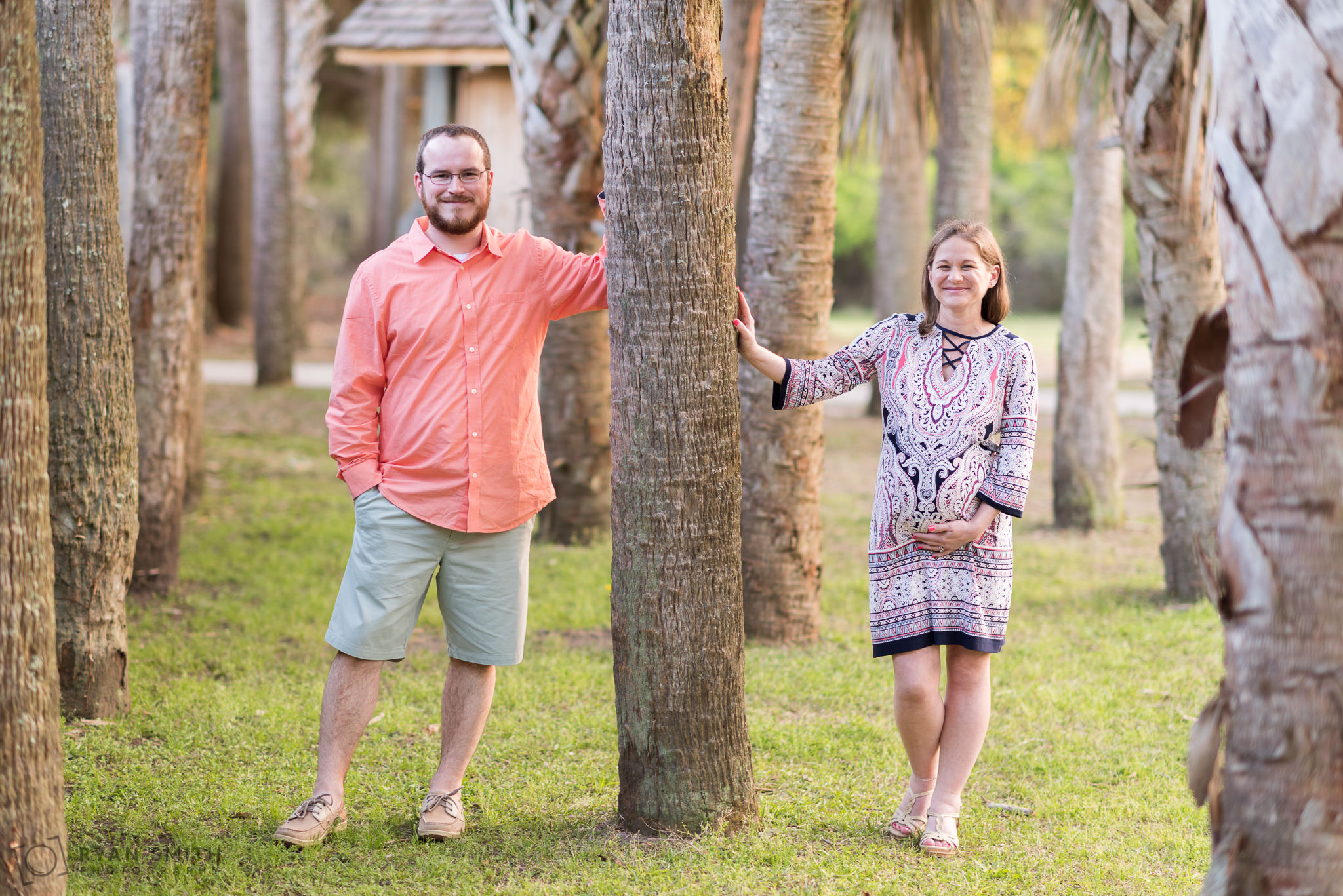 Couple posing by palm trees Huntington Beach State Park