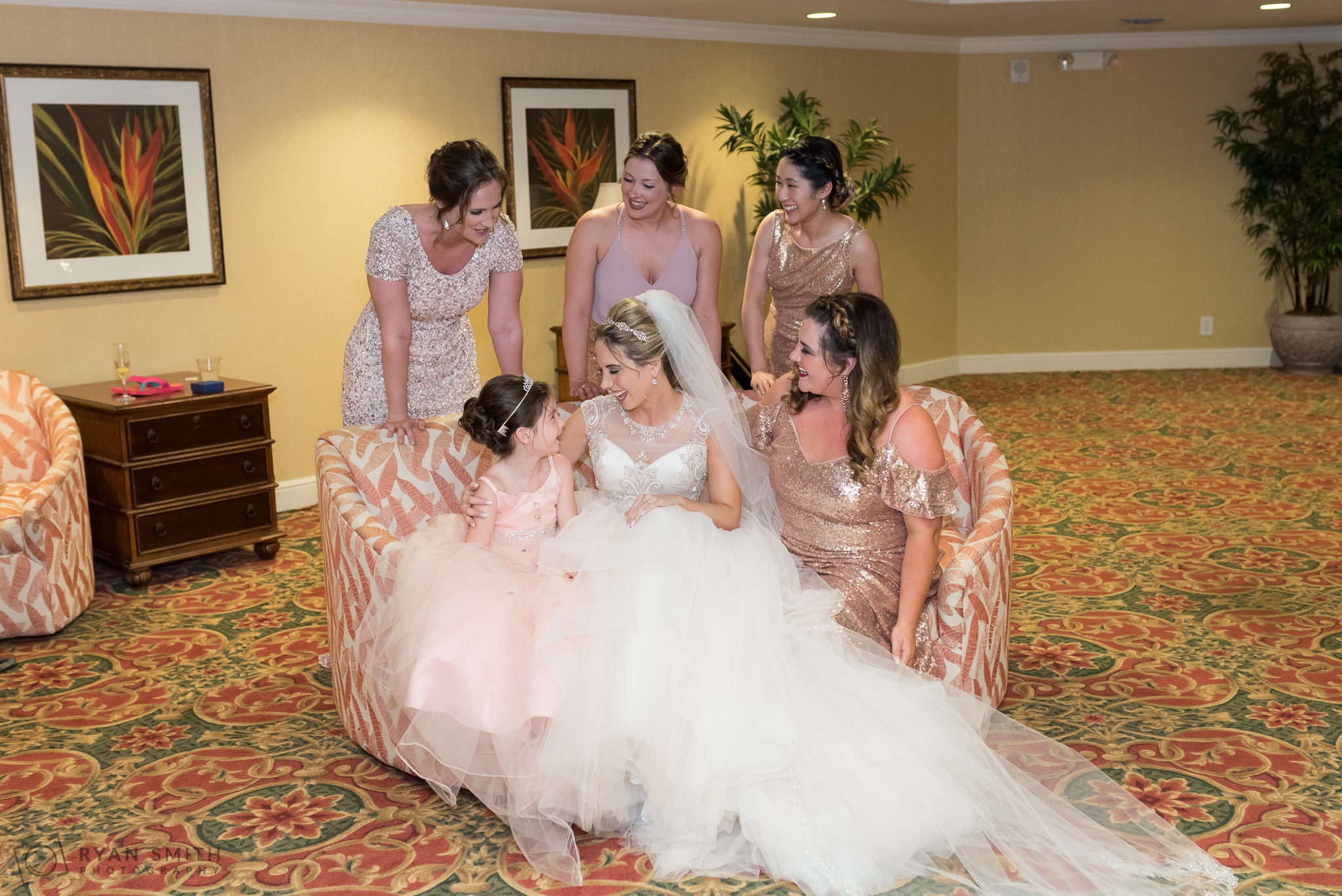 Bridesmaids and flowergirl sitting on couch Hilton Myrtle Beach Resort