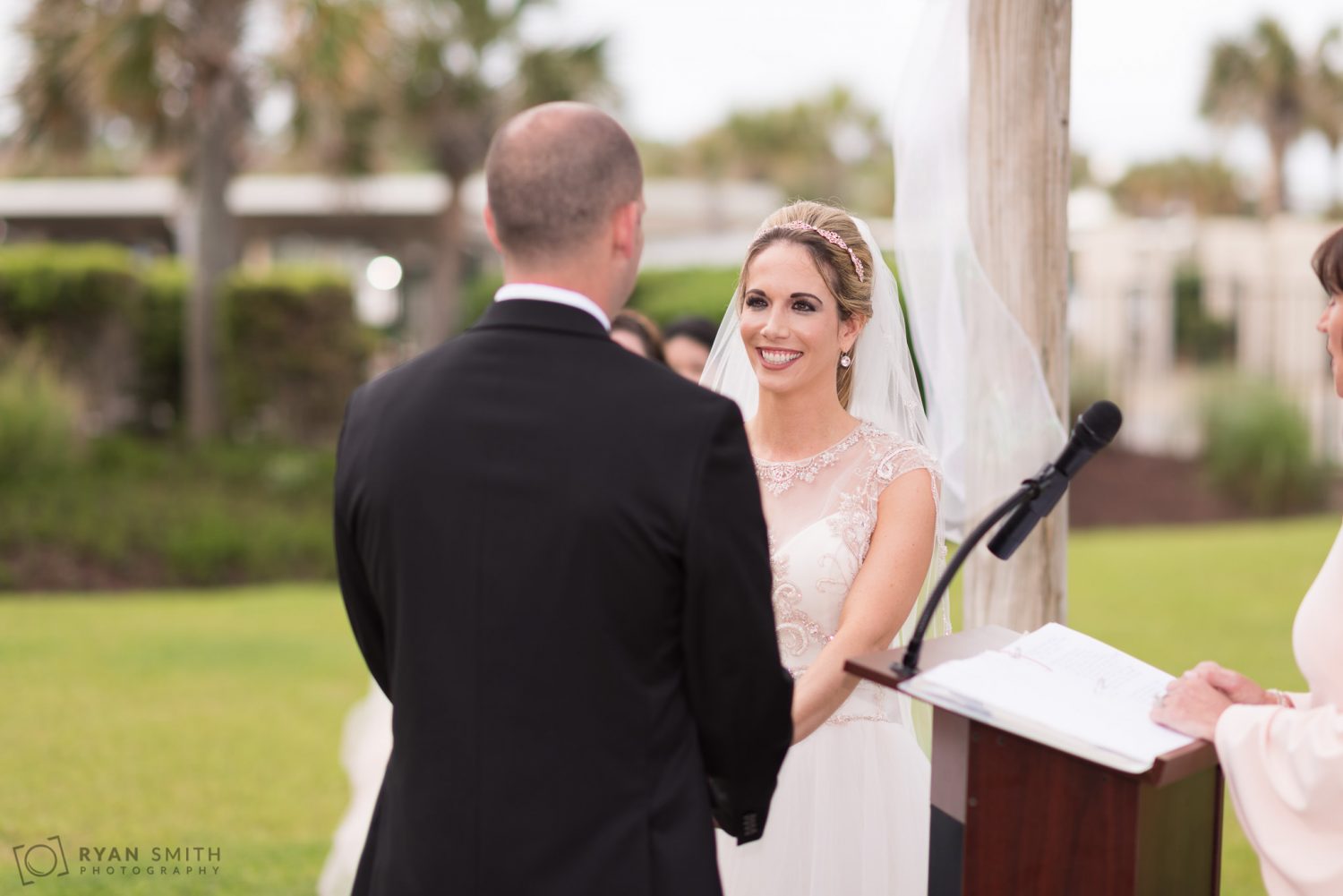 Bride smiling at groom during ceremony Hilton Myrtle Beach Resort