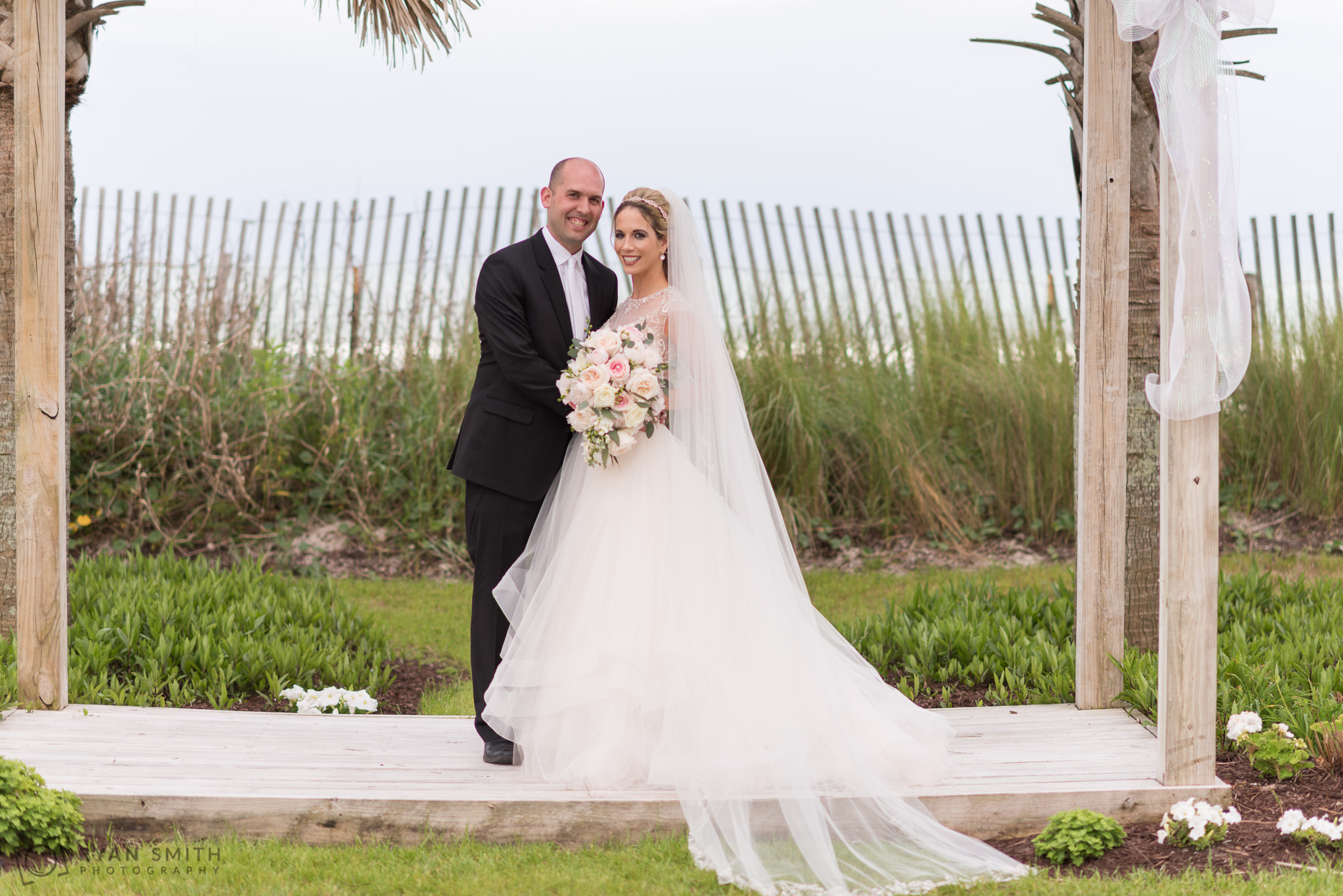 Bride and groom standing at ceremony location Hilton Myrtle Beach Resort