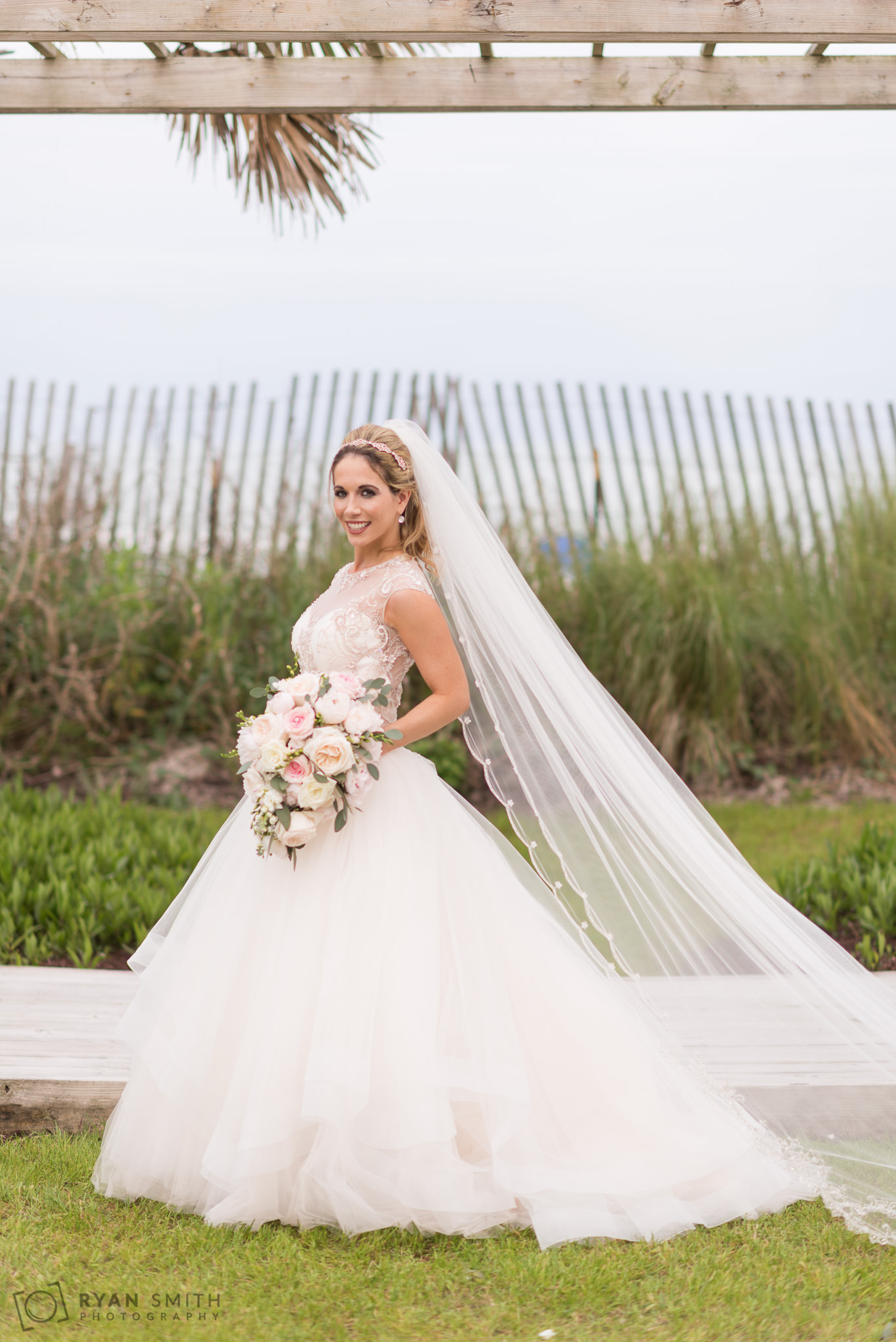Bride posing with her dress and flowers Hilton Myrtle Beach Resort