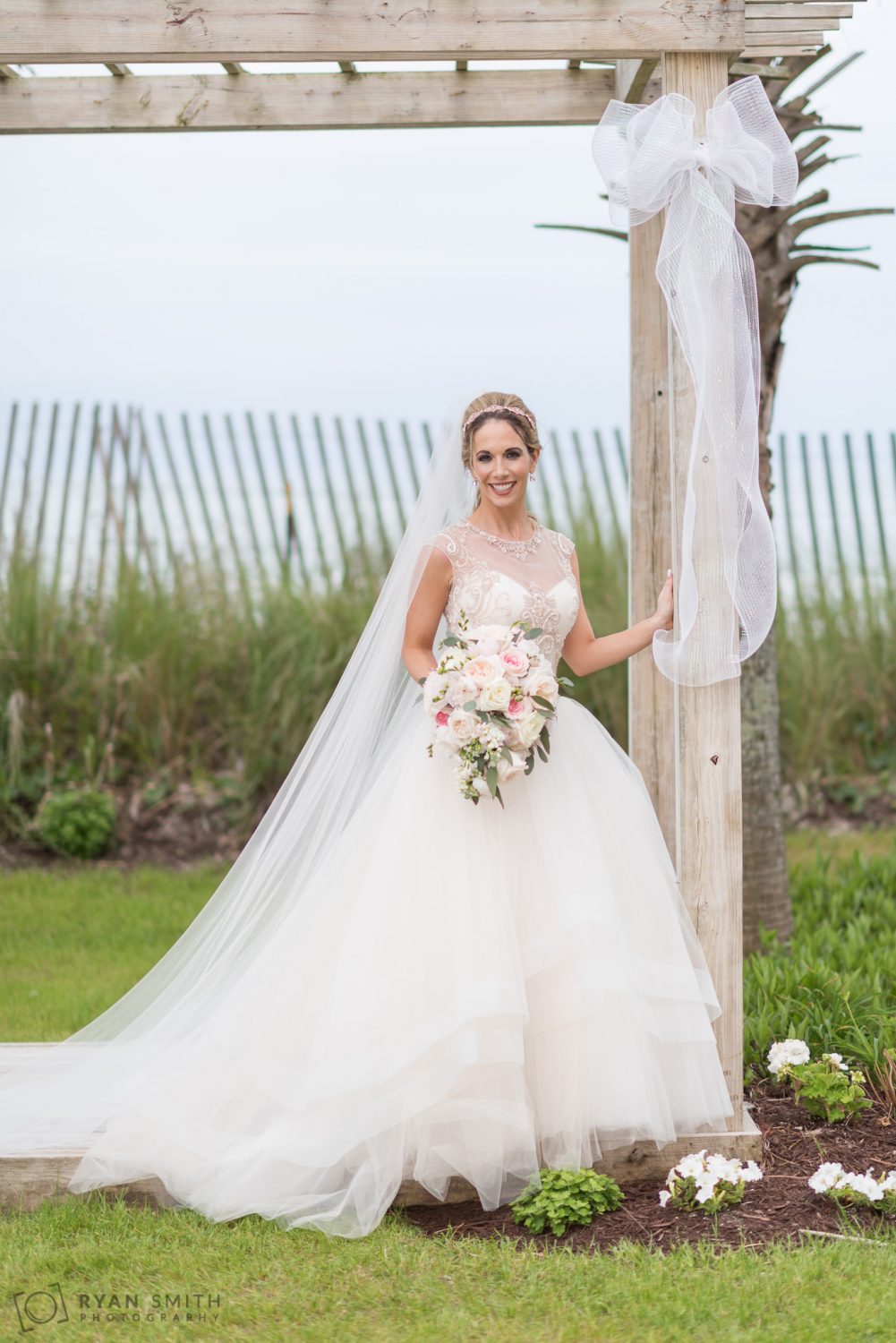 Bride leaning against the column  Hilton Myrtle Beach Resort