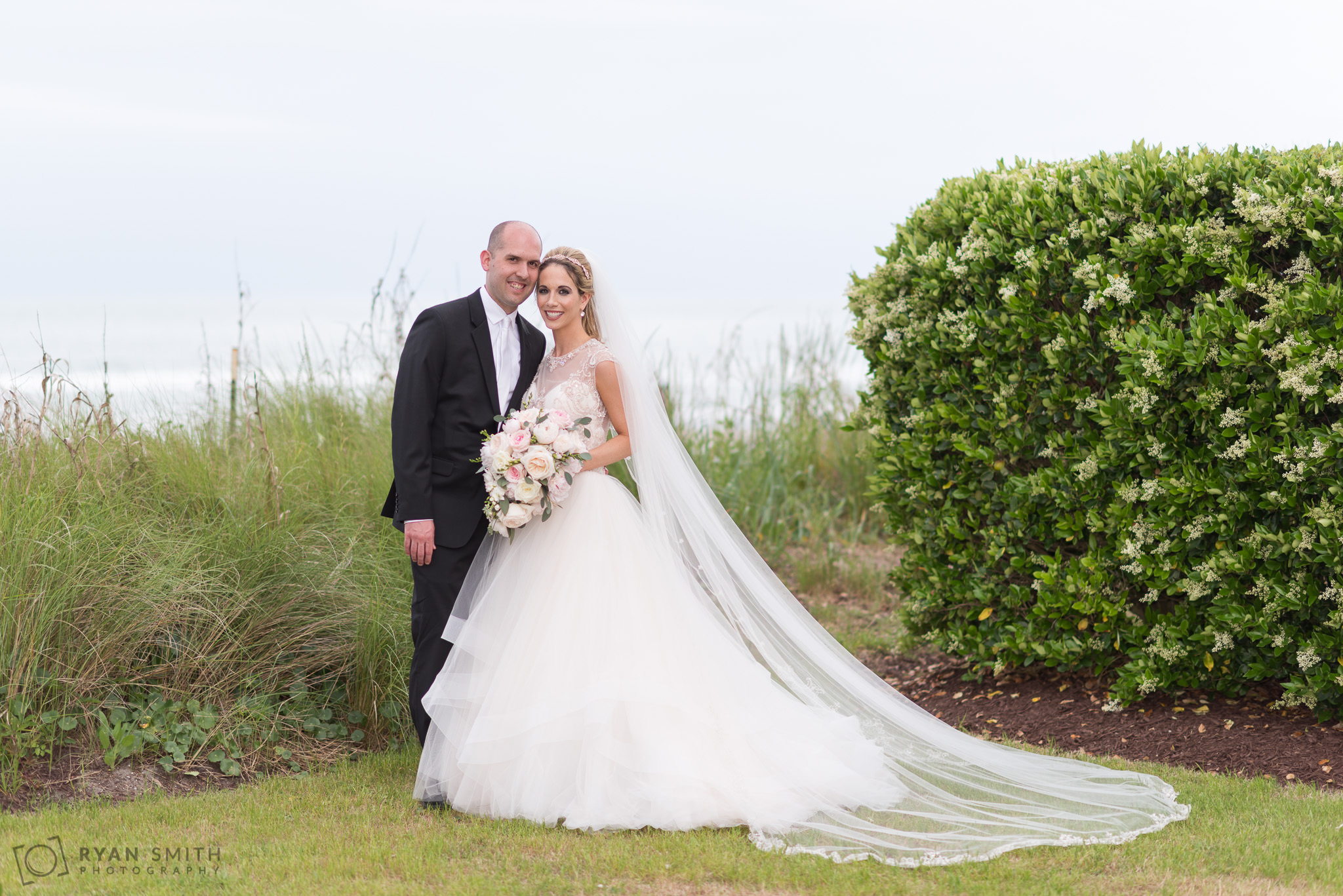 Bride and groom by the dunes Hilton Myrtle Beach Resort