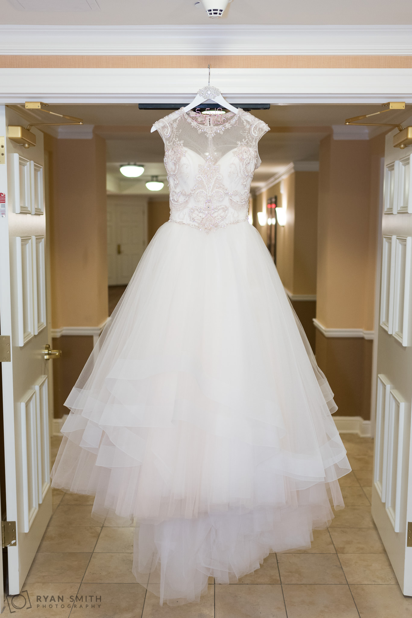 Bride's dress hanging in the doorway Hilton Myrtle Beach Resort