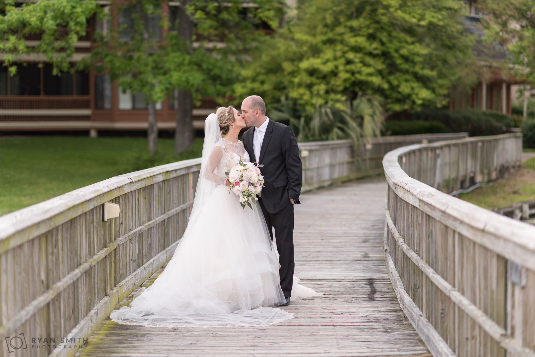 Bride and groom standing together on the bridge Kingston Plantation Myrtle Beach