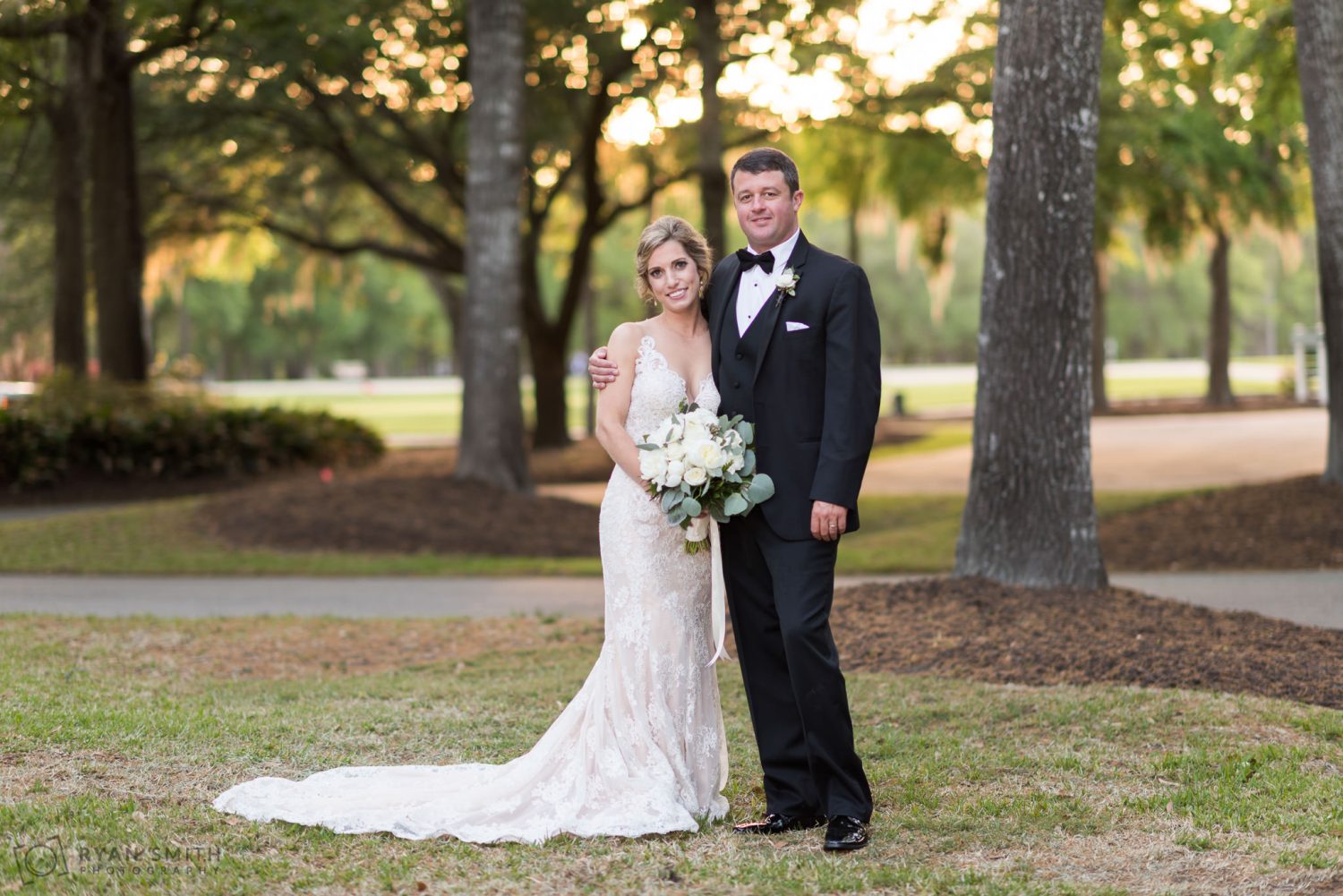 Bride and groom in front of the clubhouse Pawleys Plantation
