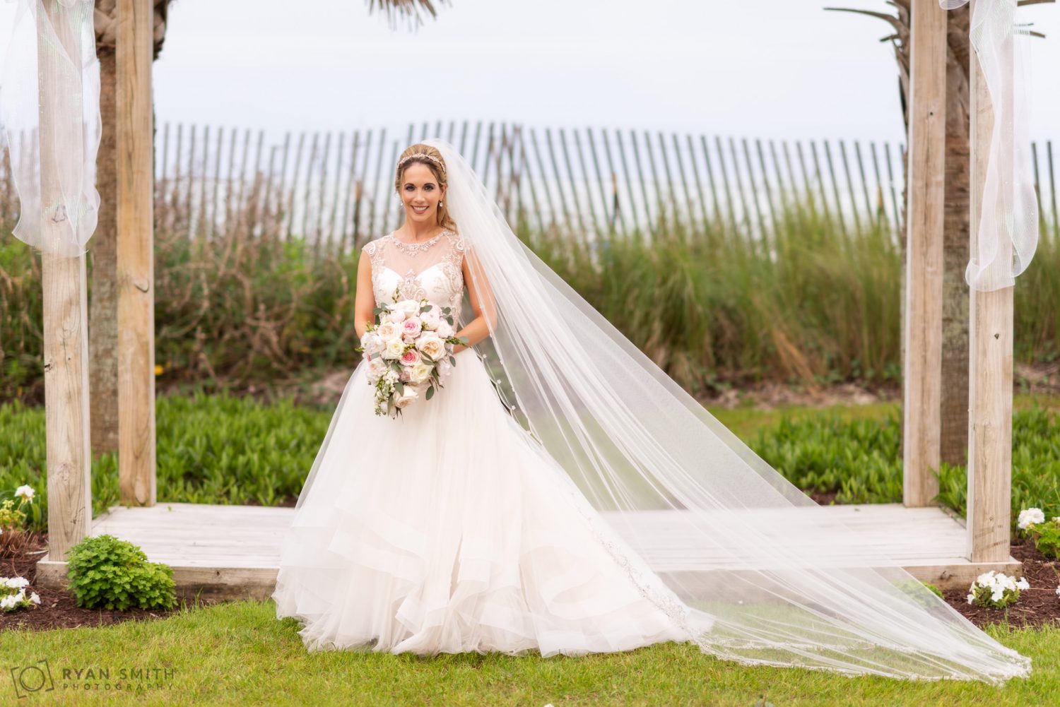Bride with long veil on the lawn Hilton Myrtle Beach Resort
