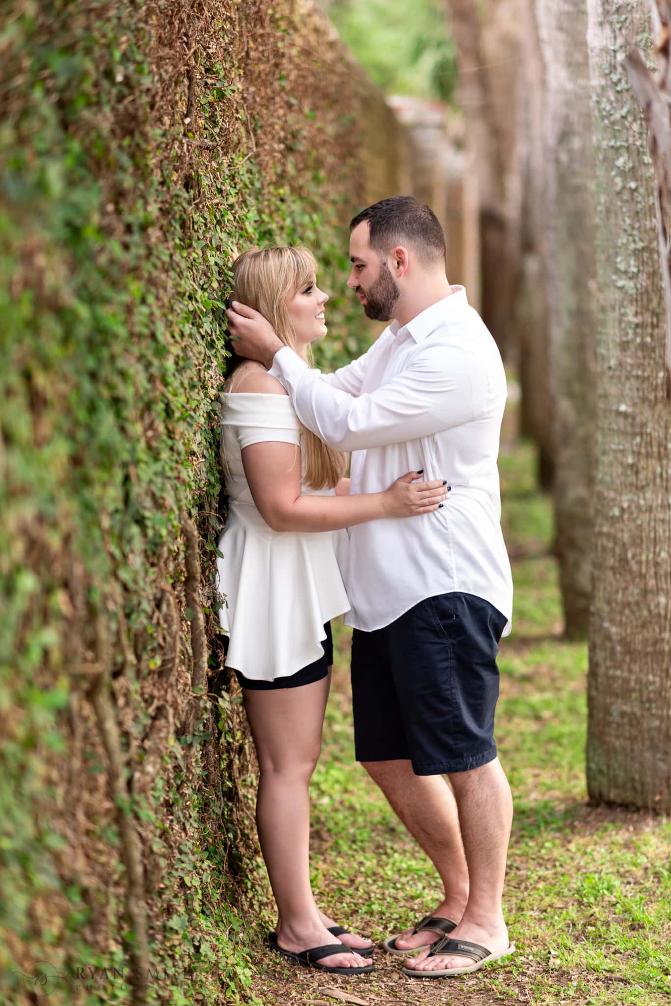 Couple looking at each other by the ivy wall - Huntington Beach State Park