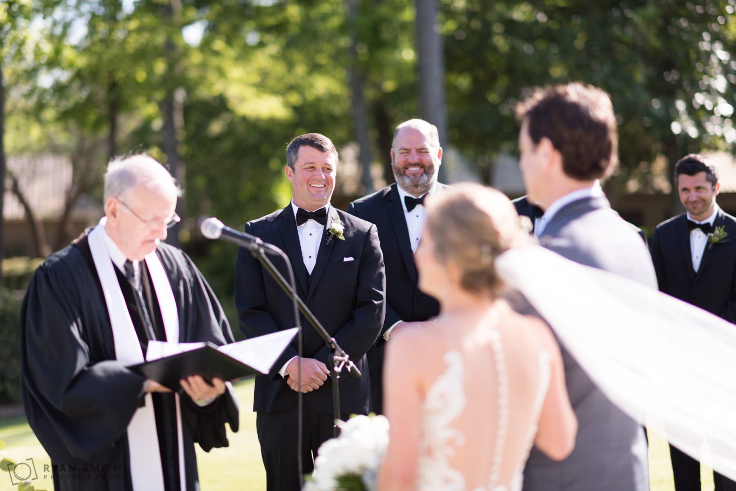 Groom laughing during the ceremony Pawleys Plantation