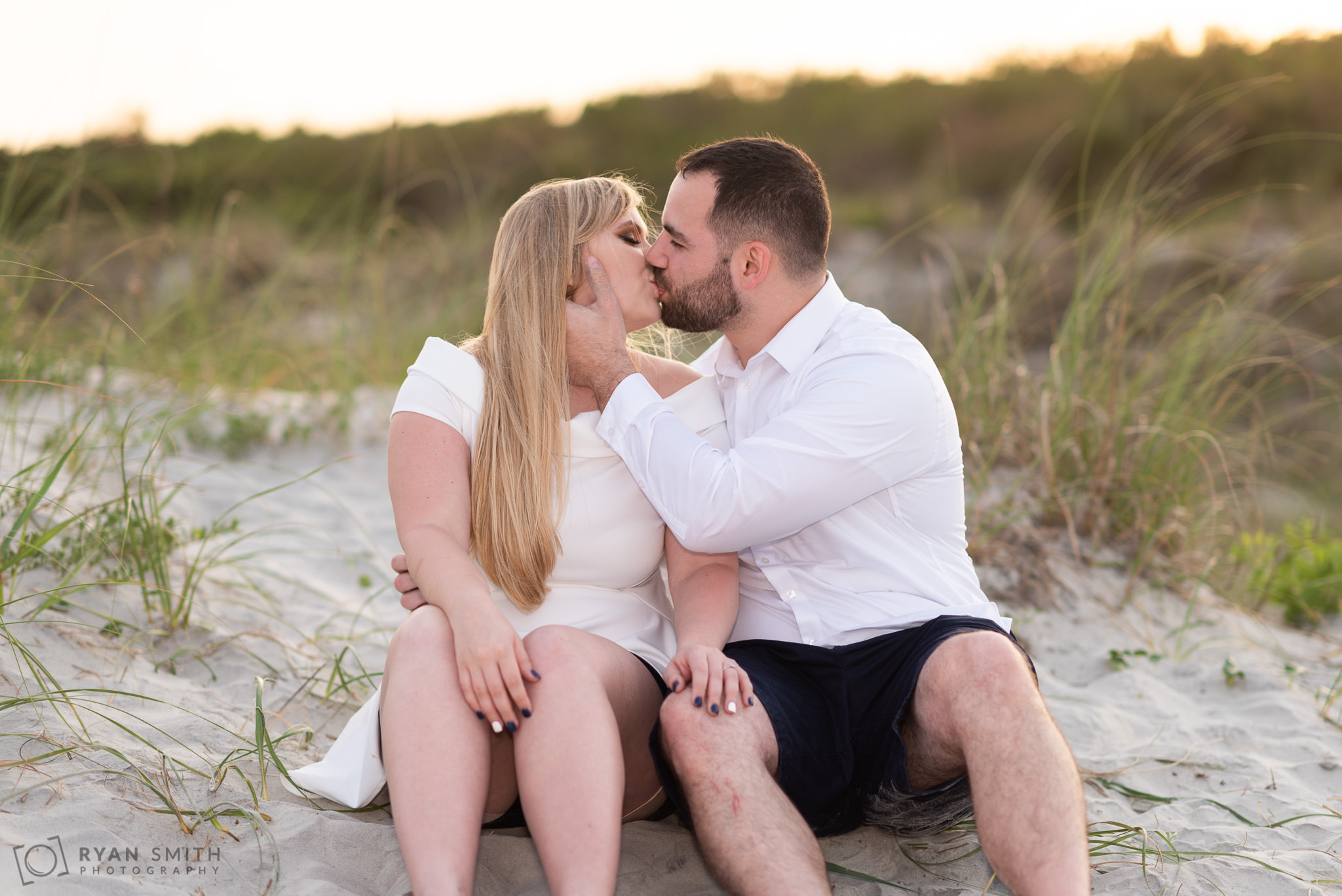 Pulling in for a kiss sitting by the dunes Huntington Beach State Park