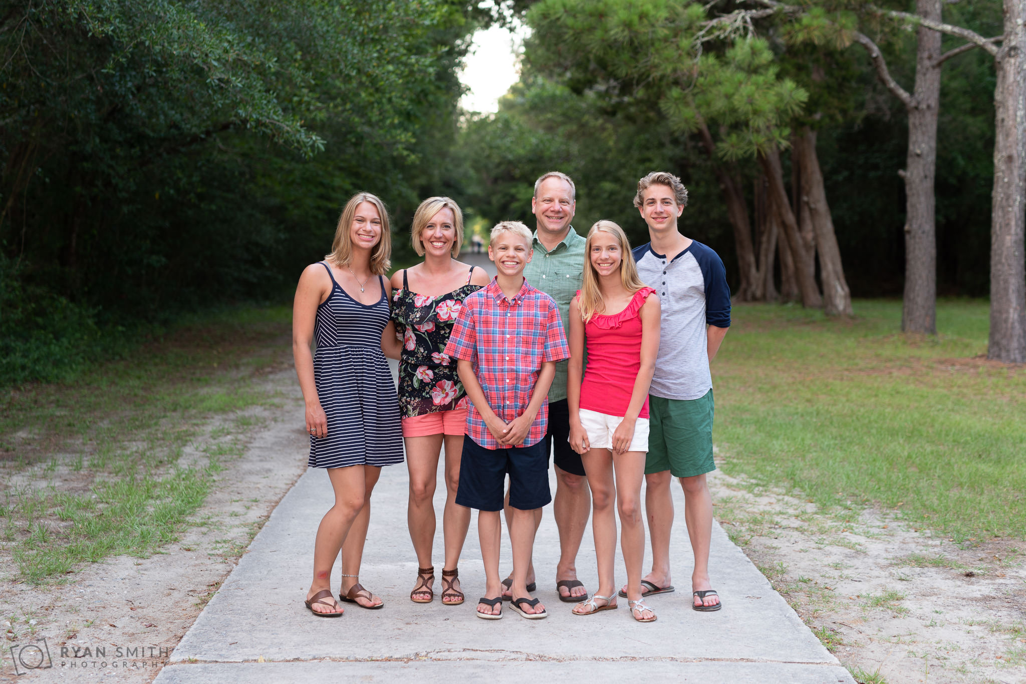 Family standing on the walkway to Brookgreen Gardens Huntington Beach State Park
