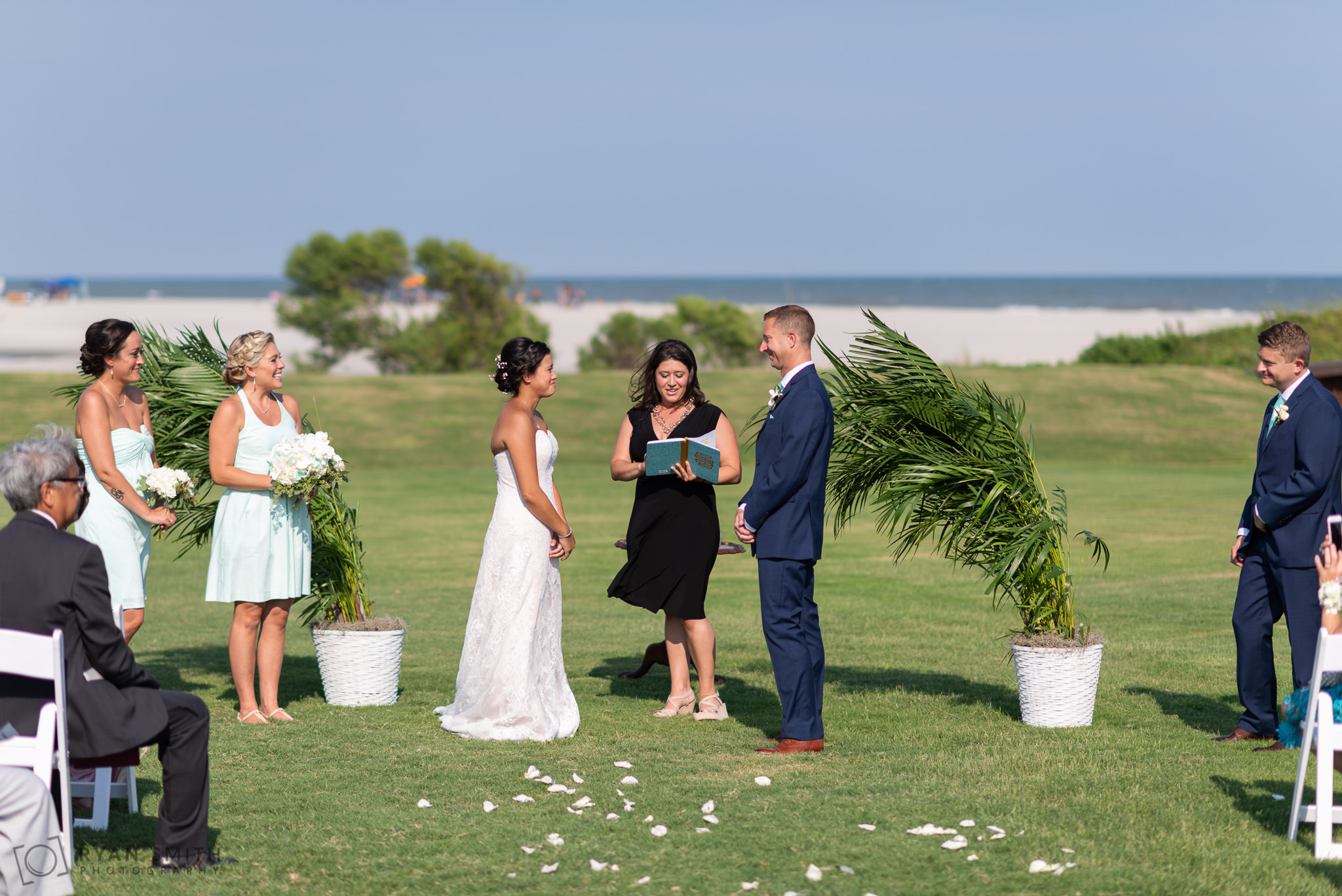 Bride and groom in front of the ocean during the ceremony Dunes Golf and Beach Club