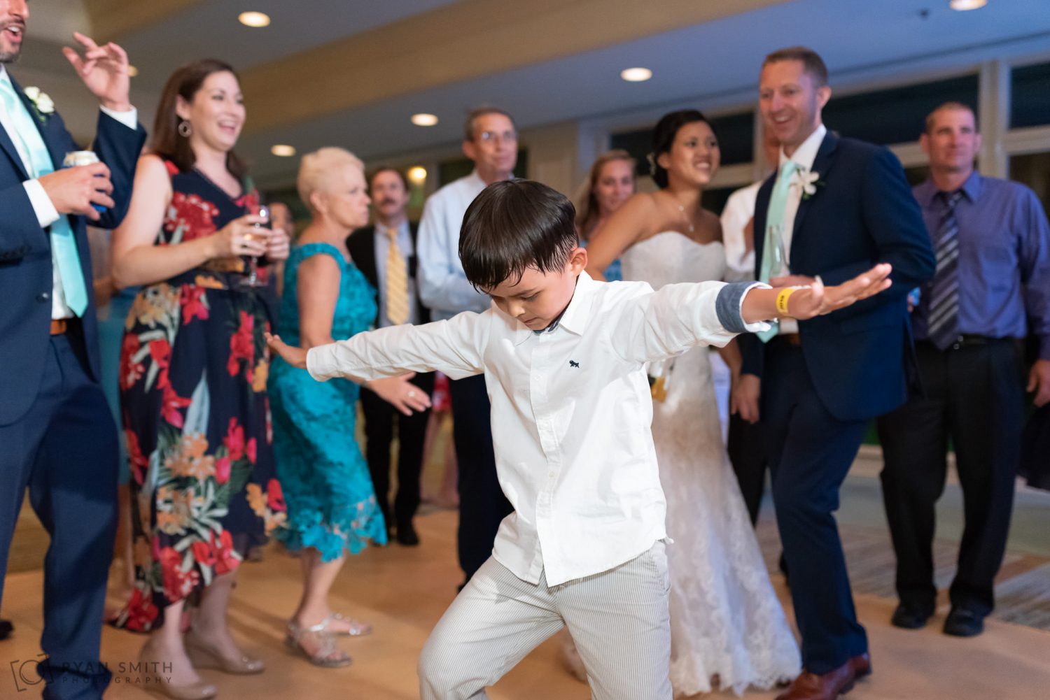 Fun dancing during the wedding reception Dunes Golf and Beach Club