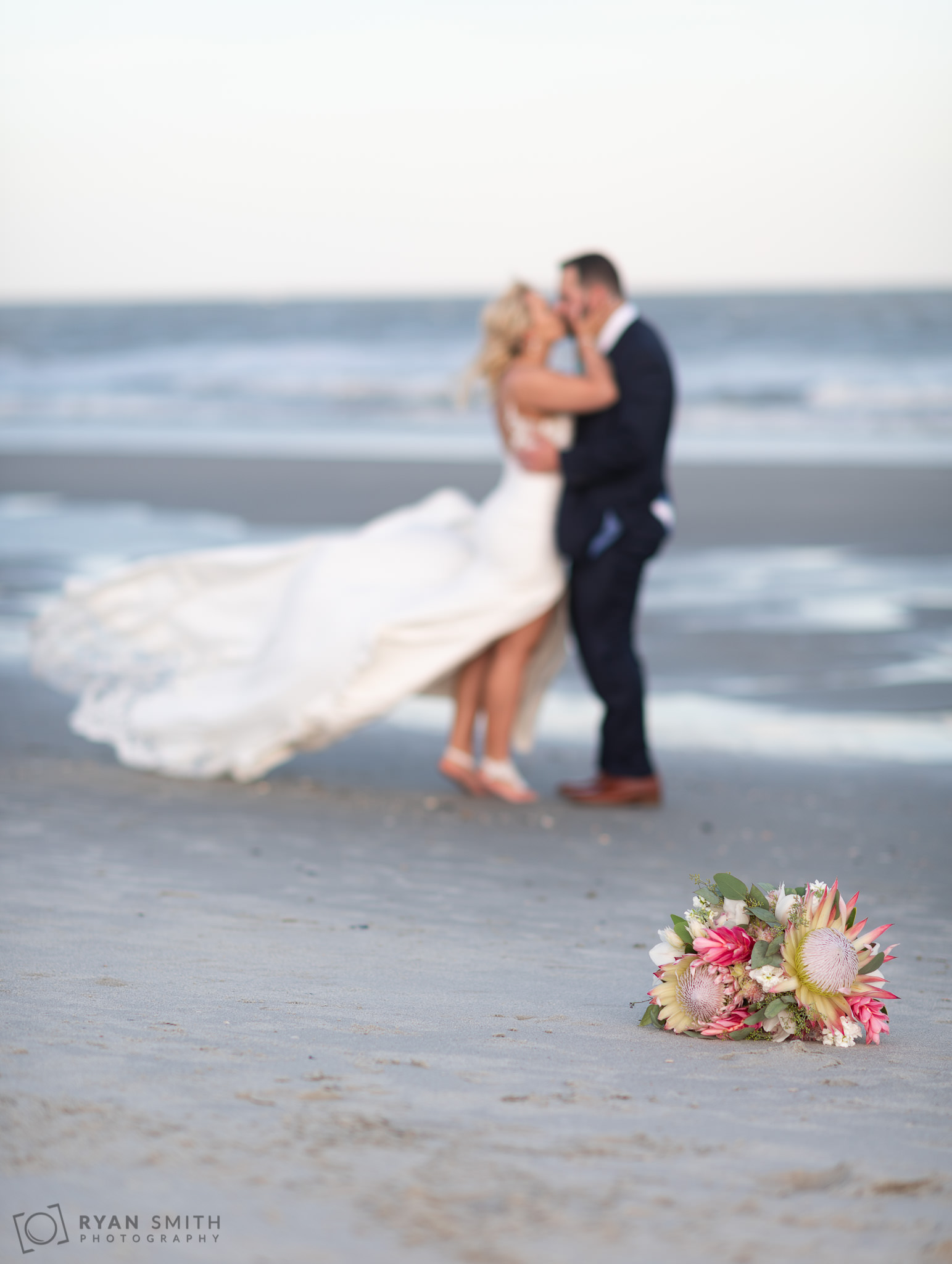 Kiss with the flowers in the foreground  Grande Dunes Ocean Club