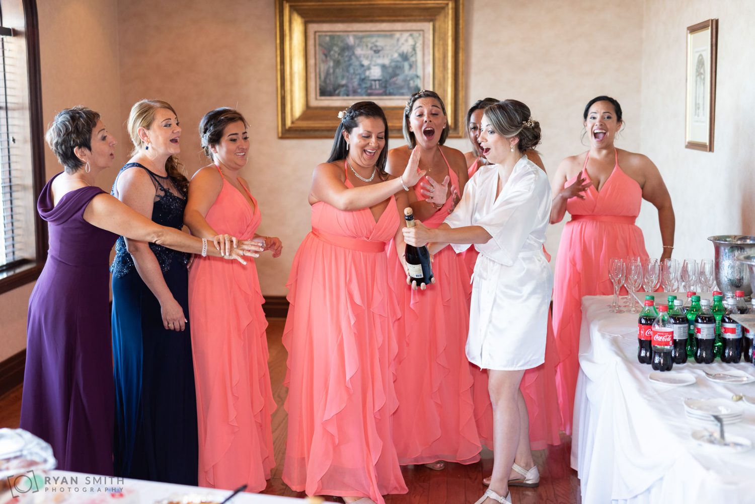 Bride and bridesmaids opening the wine bottle Grande Dunes Ocean Club