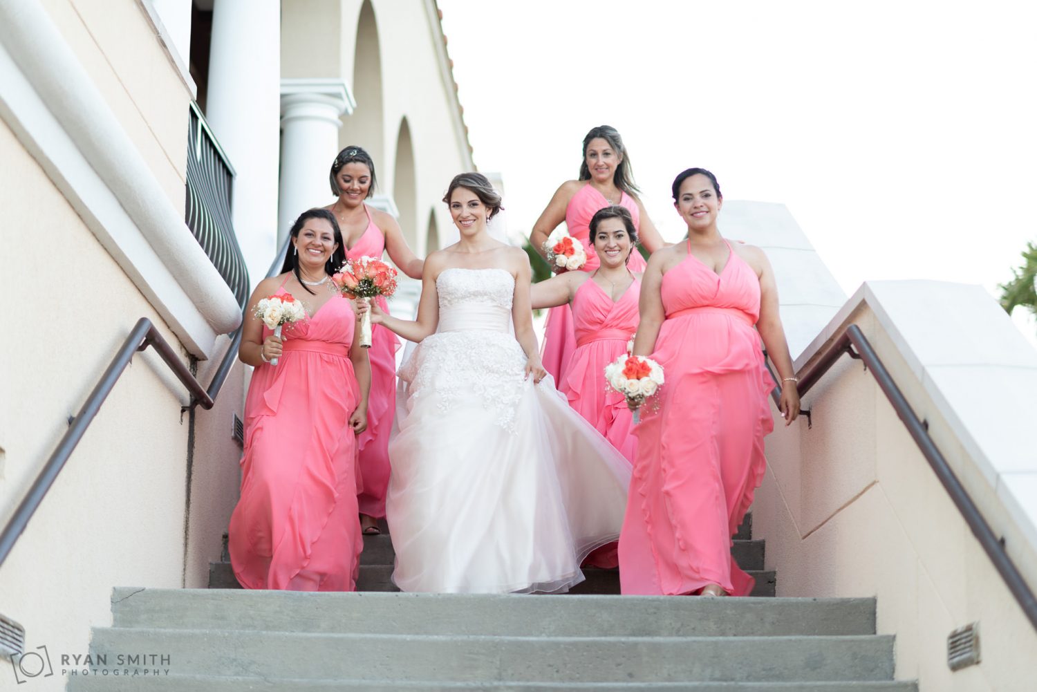 Bride and bridesmaids walking down the steps Grande Dunes Ocean Club