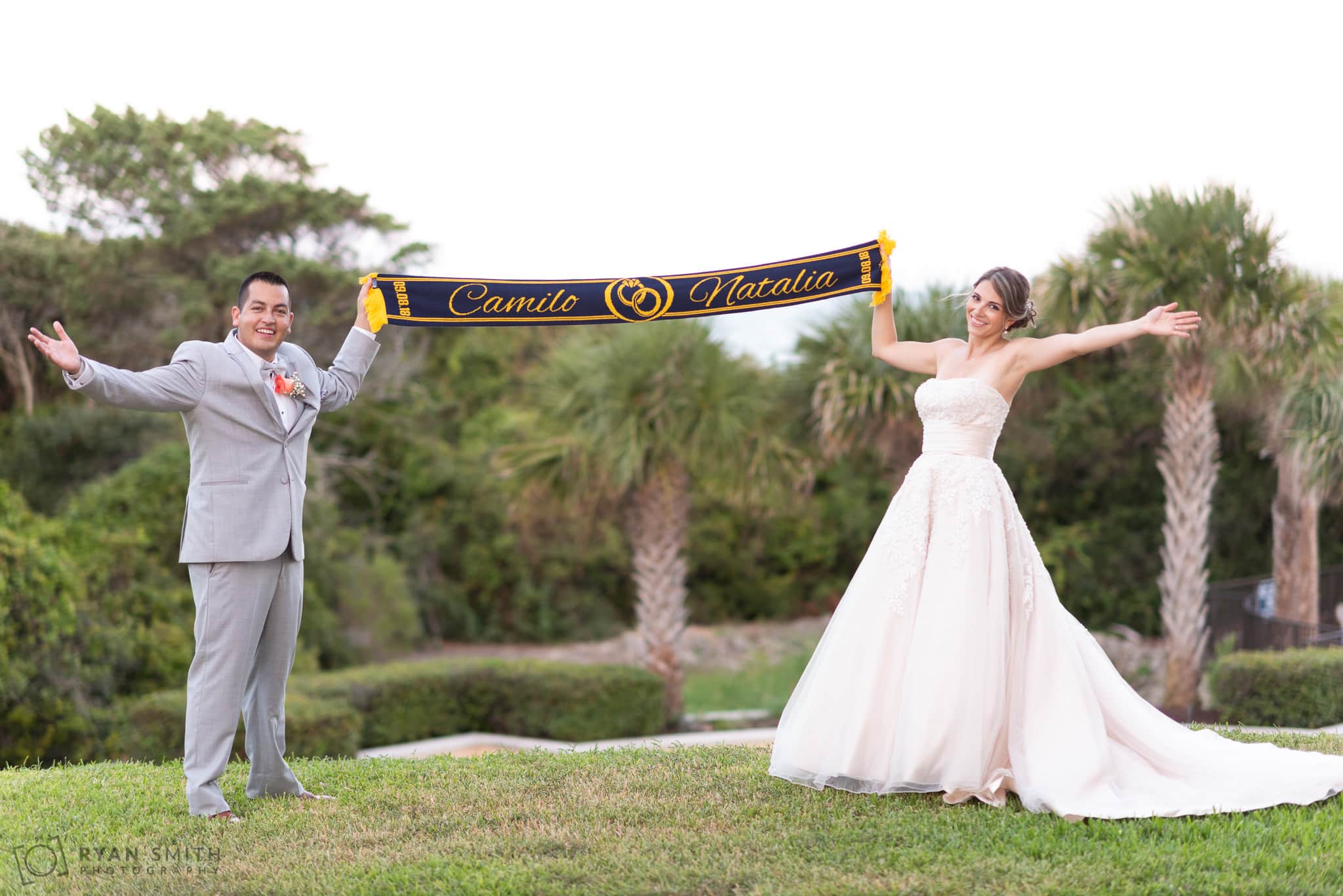 Bride and groom holding Colombian color scarf with their names Grande Dunes Ocean Club