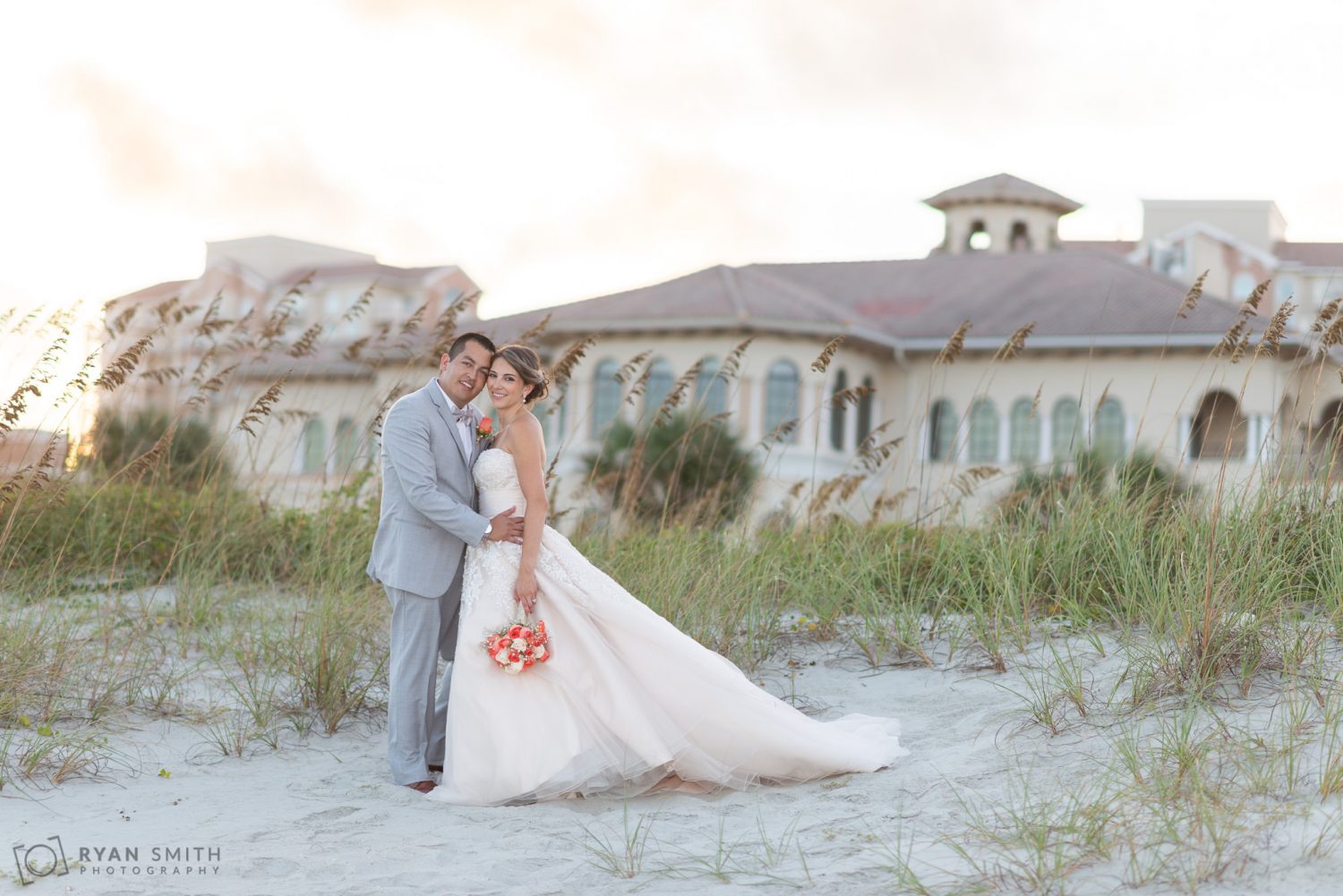 Bride and groom with the dunes and club in the background Grande Dunes Ocean Club