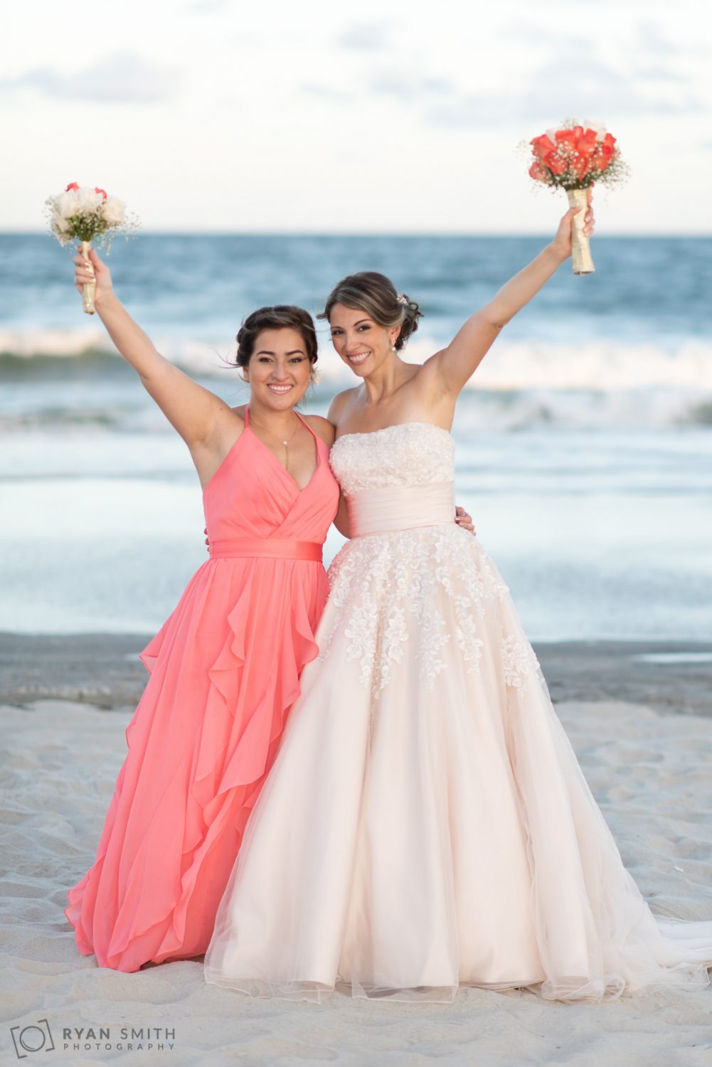 Bride and sister holding flower in the air Grande Dunes Ocean Club