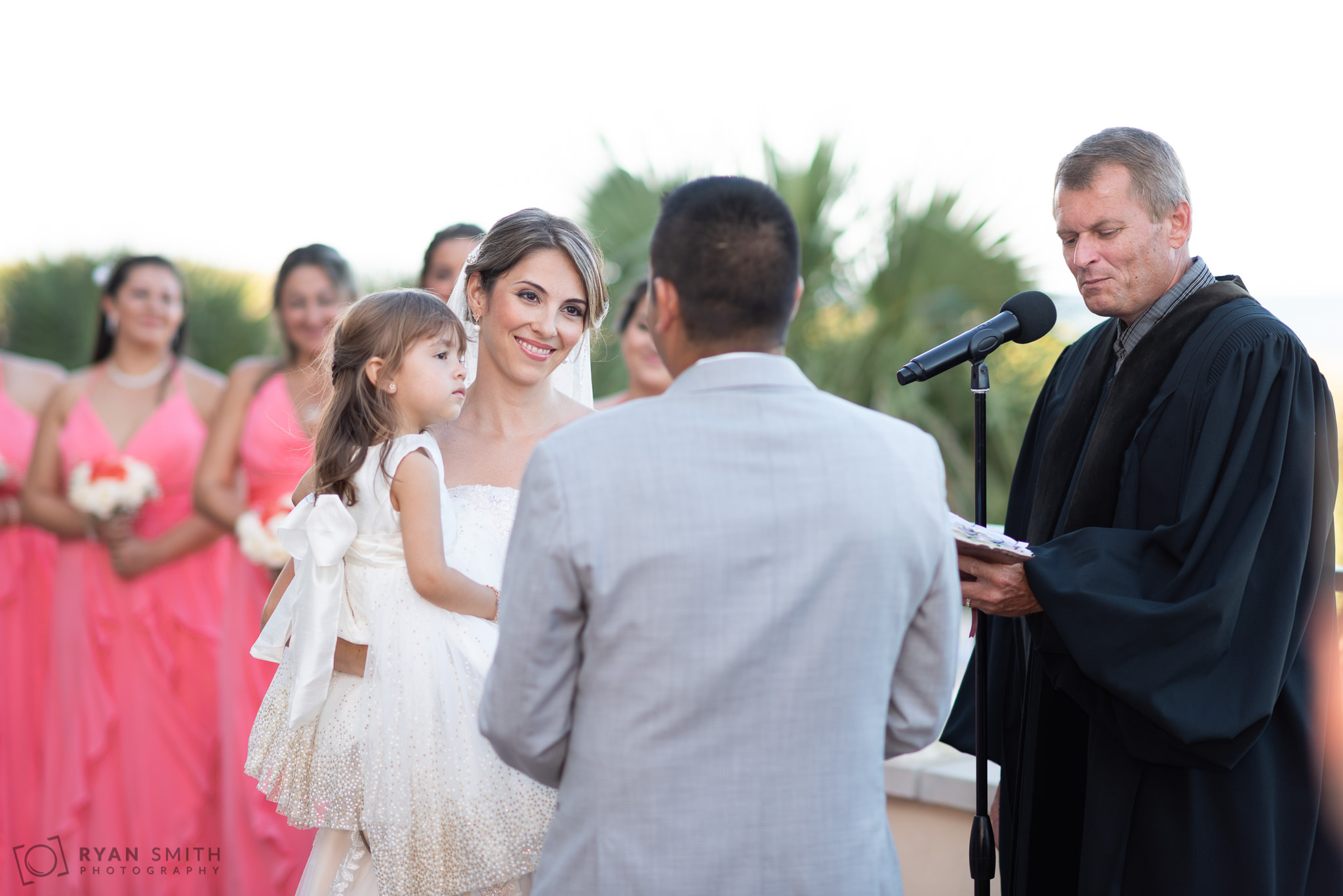 Bride looking at groom holding daughter during the ceremony Grande Dunes Ocean Club