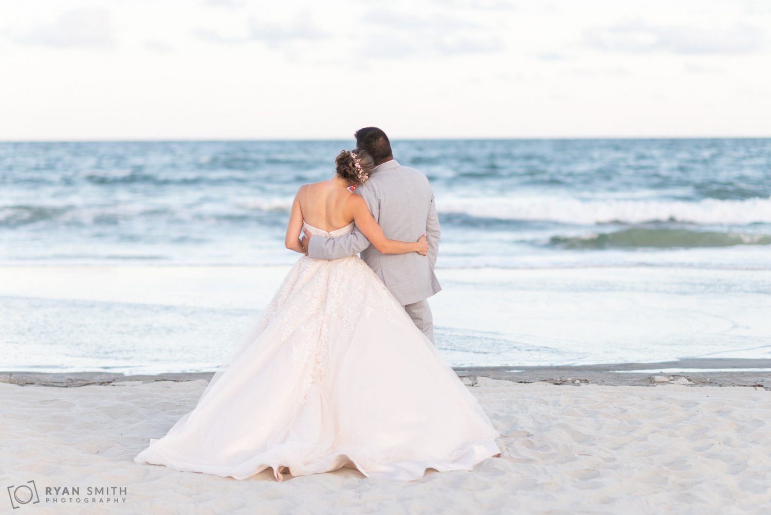 Bride with her head on groom's shoulder  Grande Dunes Ocean Club
