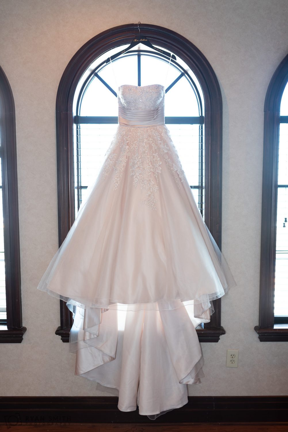 Bride's dress hanging in the window Grande Dunes Ocean Club