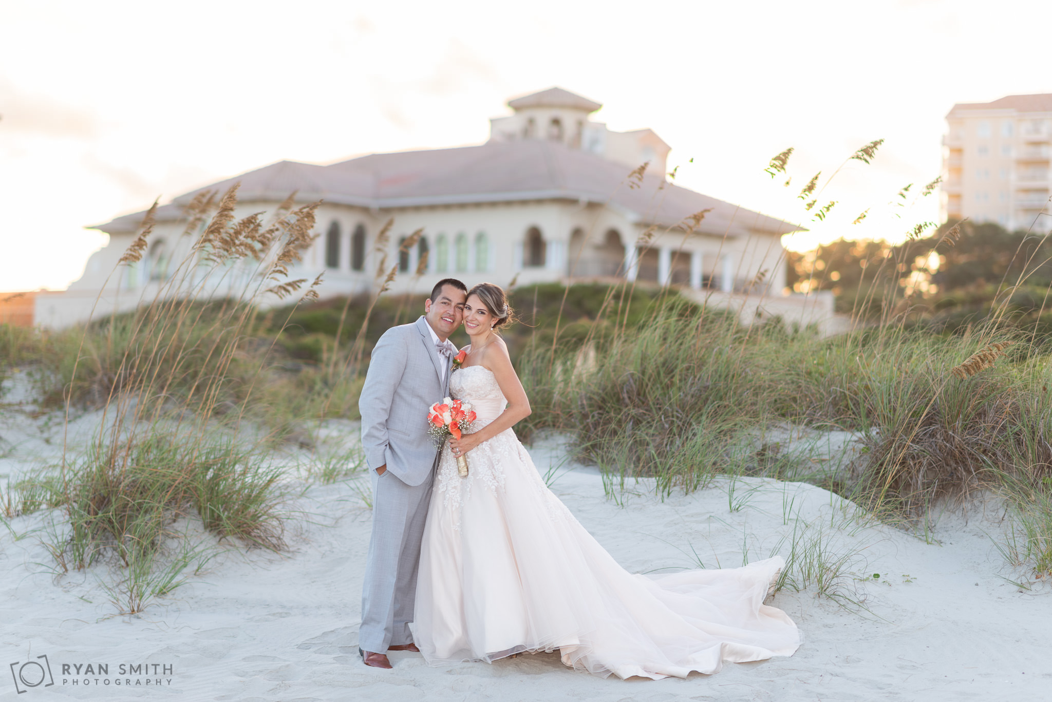 Couple in front of the ocean club at sunset Grande Dunes Ocean Club