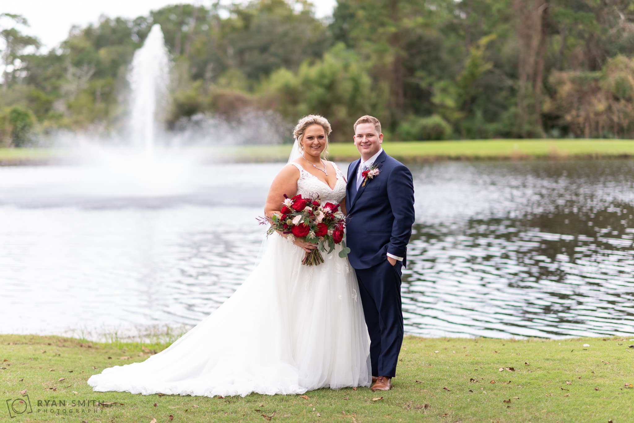 Bride and groom in front of the lake