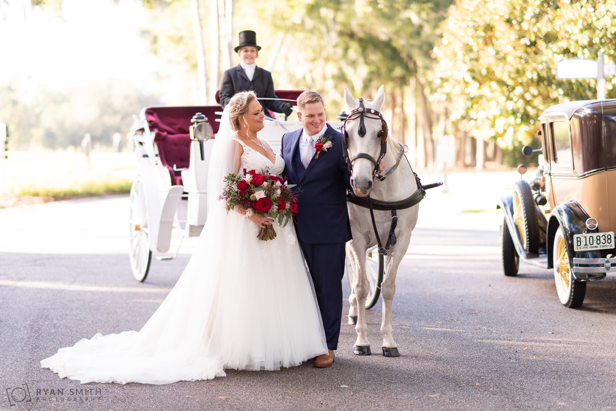 Bride and groom looking at the horse