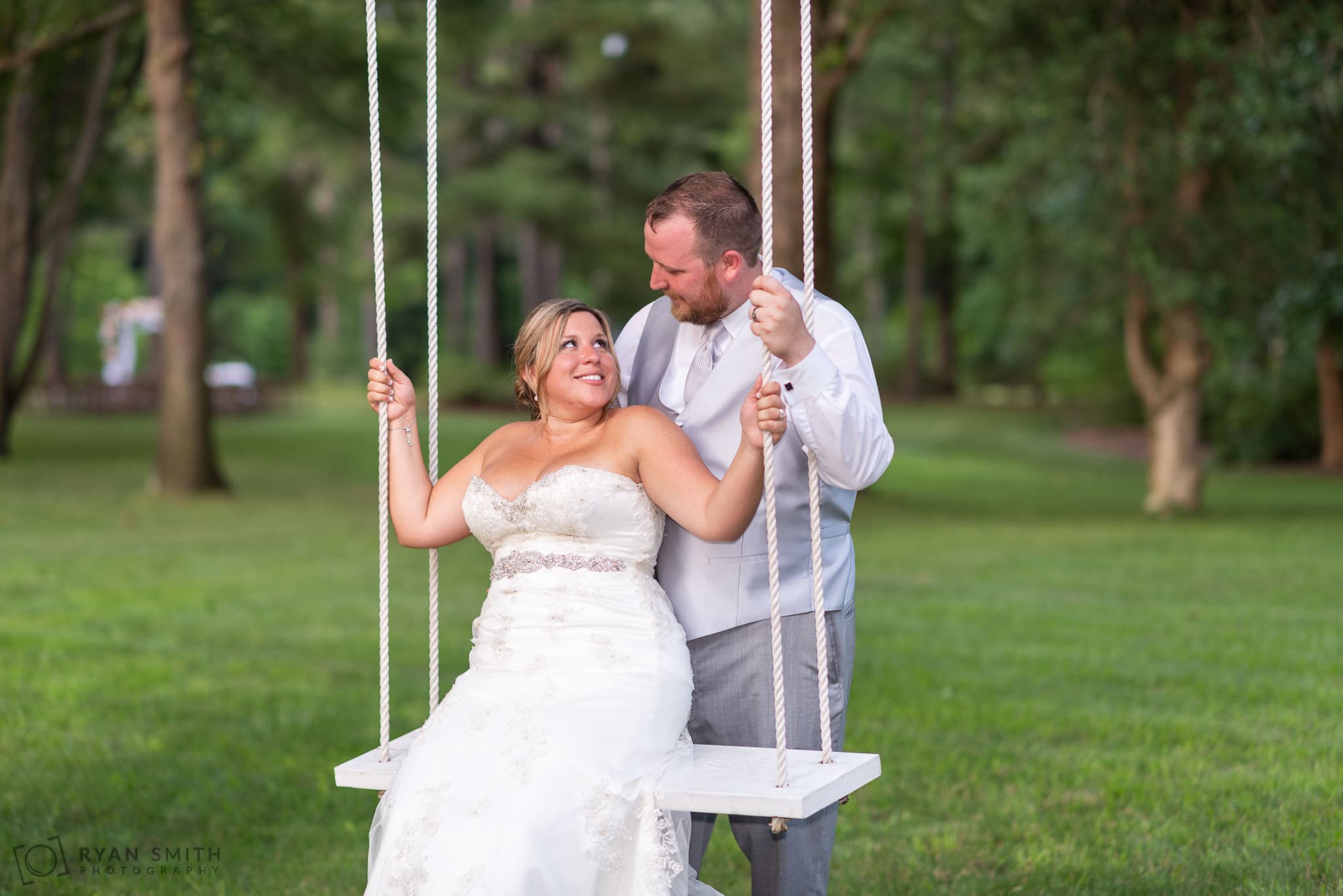 Bride smiling at groom on the swing Wildberry Farm