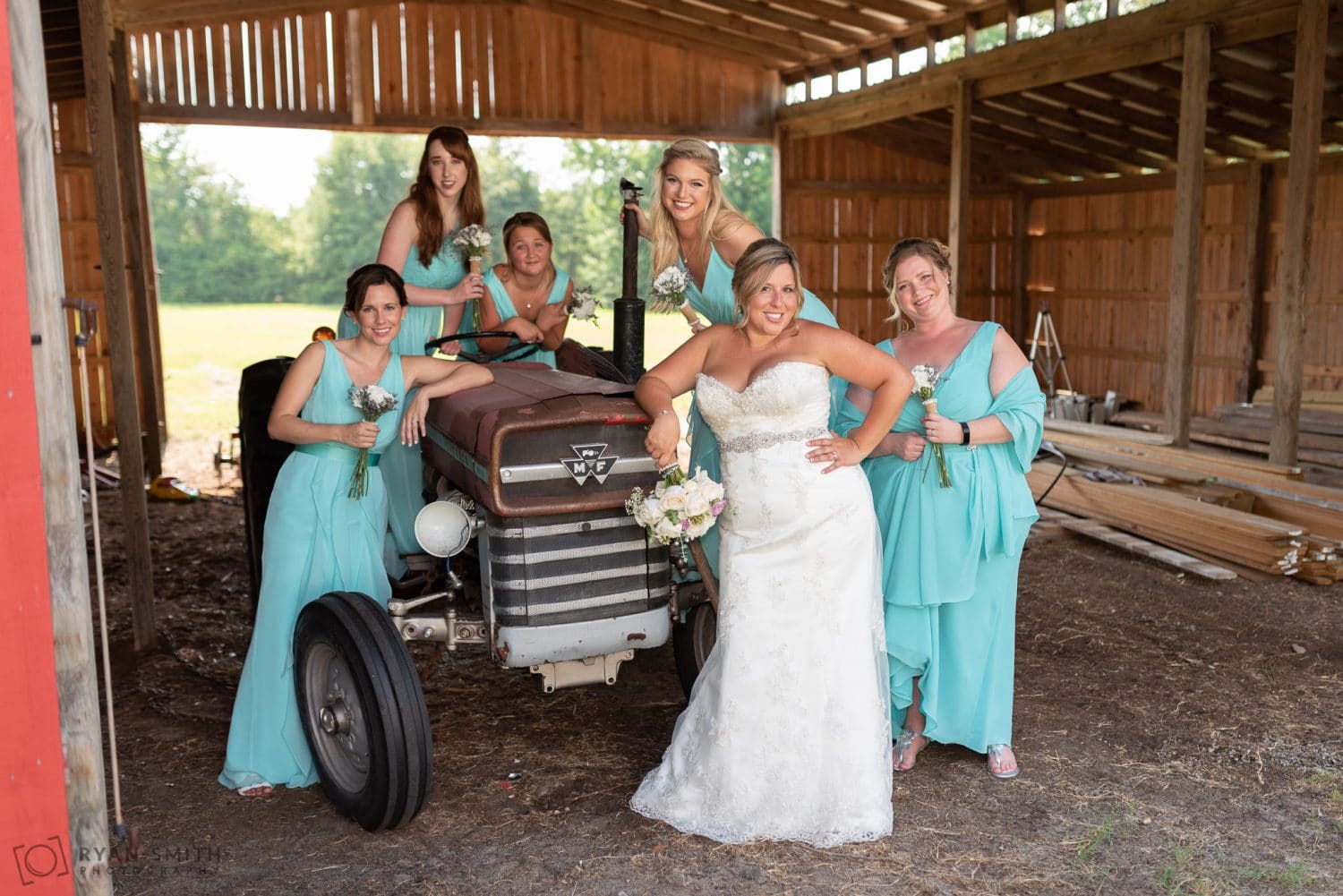 Bridesmaids hanging out by the tractor Wildberry Farm