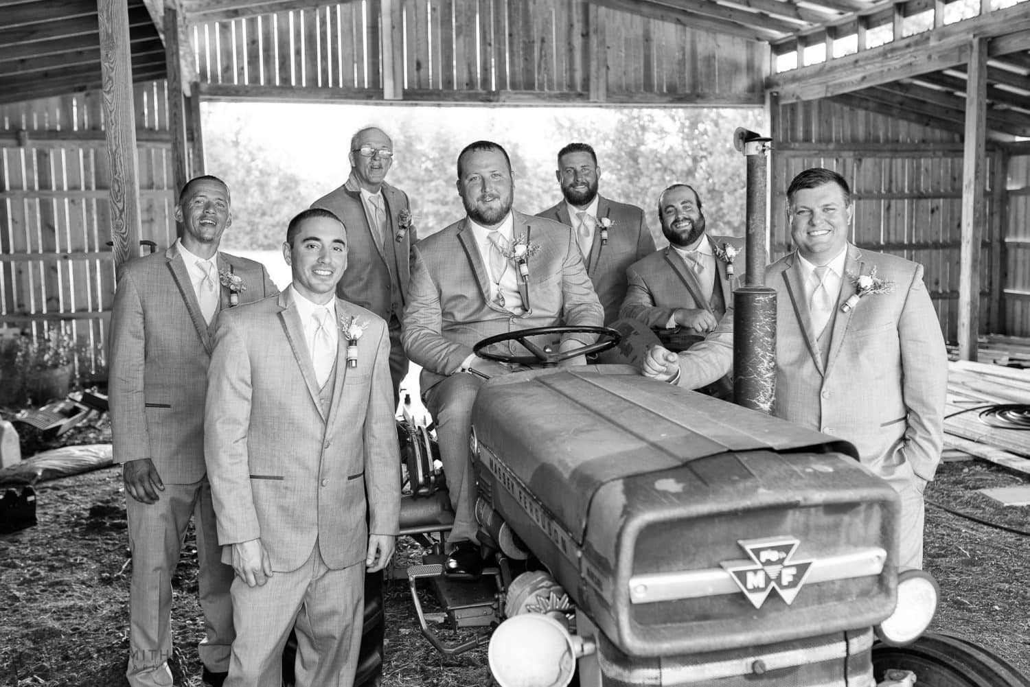 Groomsmen hanging out on the tractor  Wildberry Farm