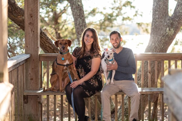 Couple sitting on a bench with their two dogs - Vereen Memorial Gardens