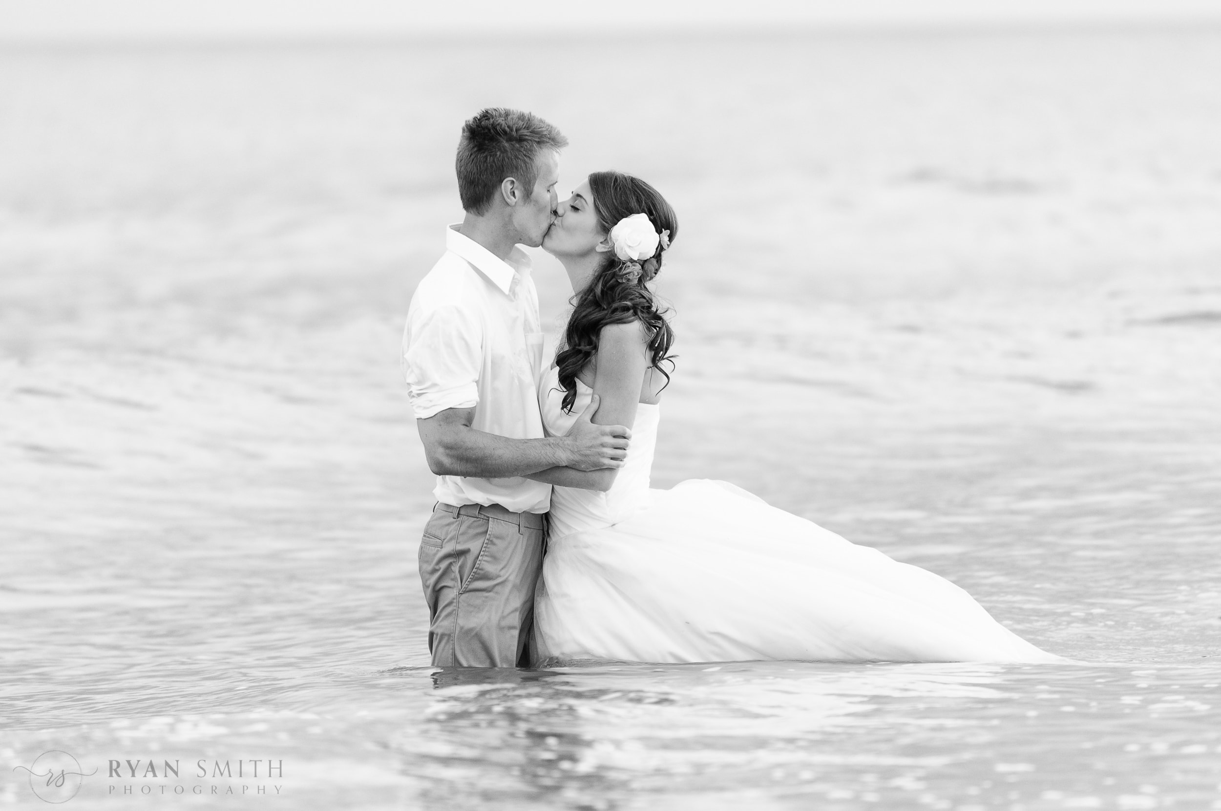 Bride and groom deep in ocean together - Ocean Isle