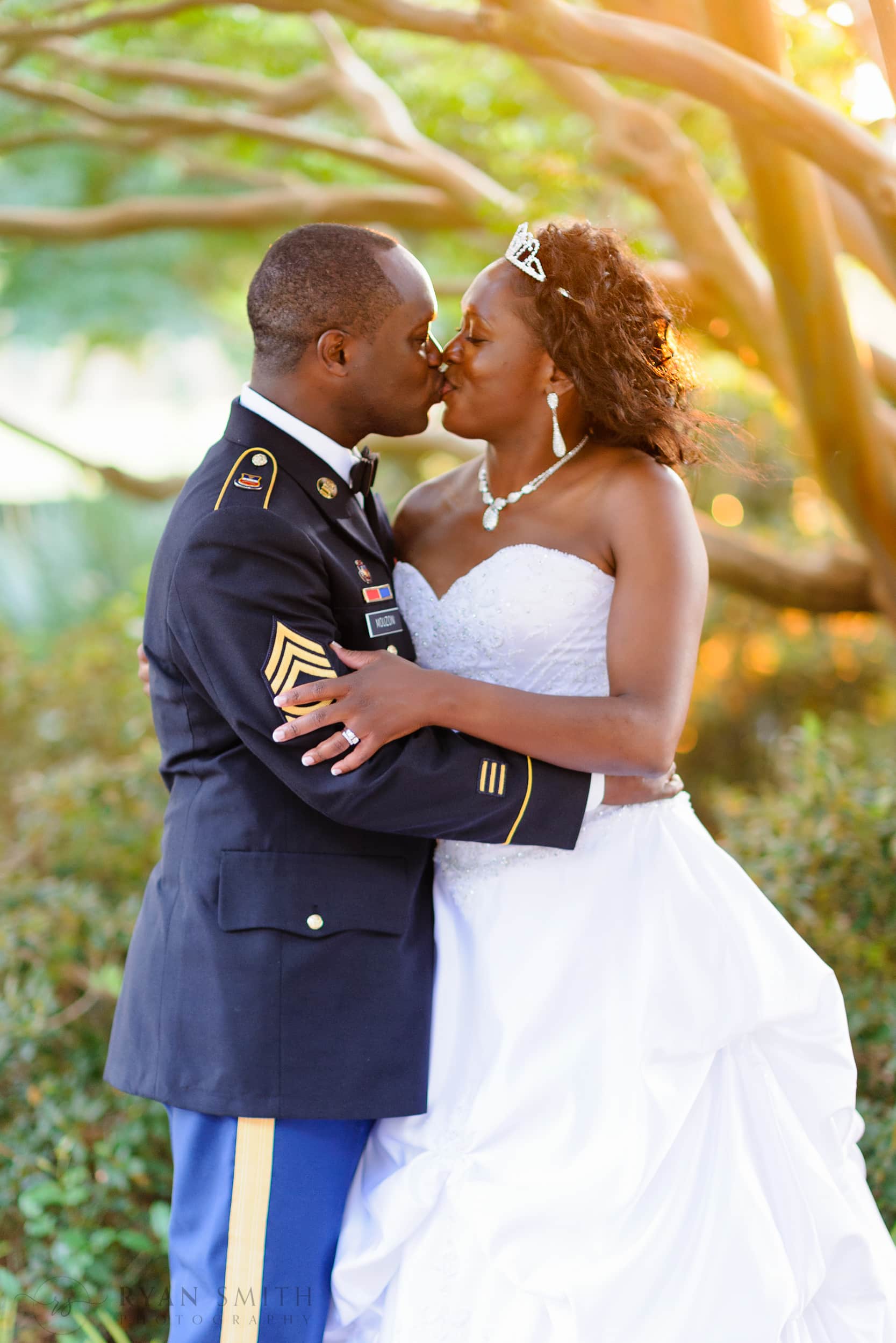 Bride and groom in military uniform backlit by sunset - Pine Lakes