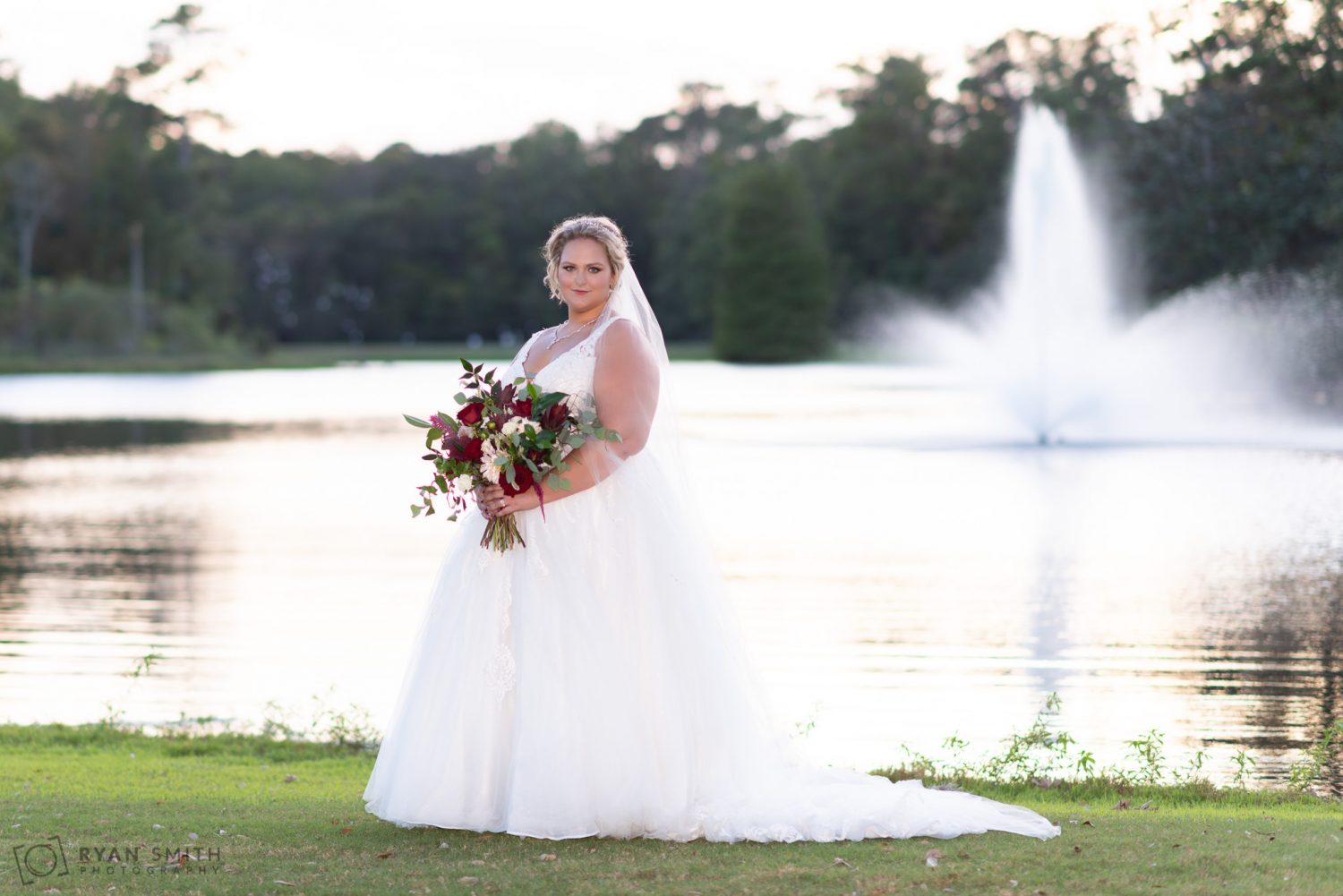 Bride beside the lake in the sunset Pawleys Plantation Golf & Country Club