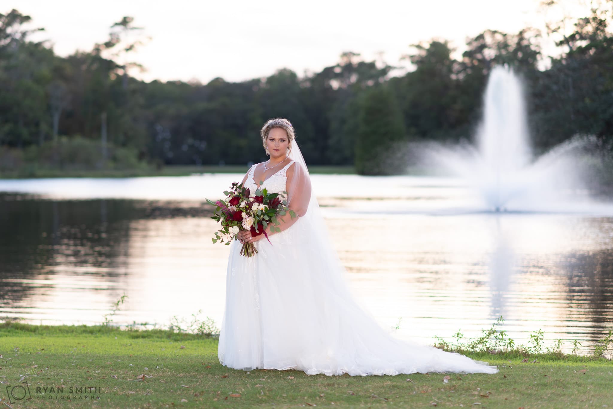 Bride holder her flowers at sunset Pawleys Plantation Golf & Country Club