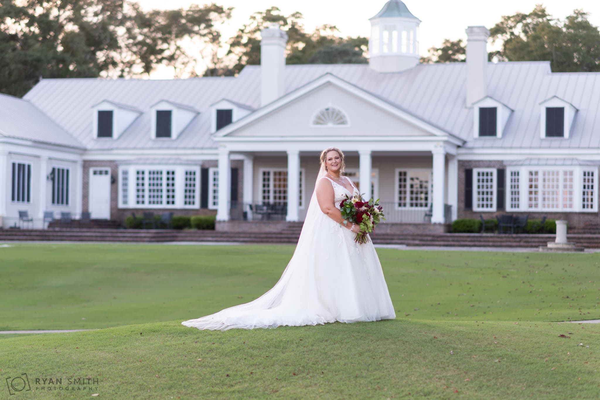 Bride laughing on the golf course hill Pawleys Plantation Golf & Country Club