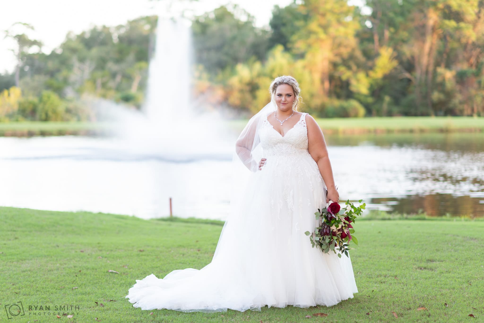Bride posing by the fountain Pawleys Plantation Golf & Country Club