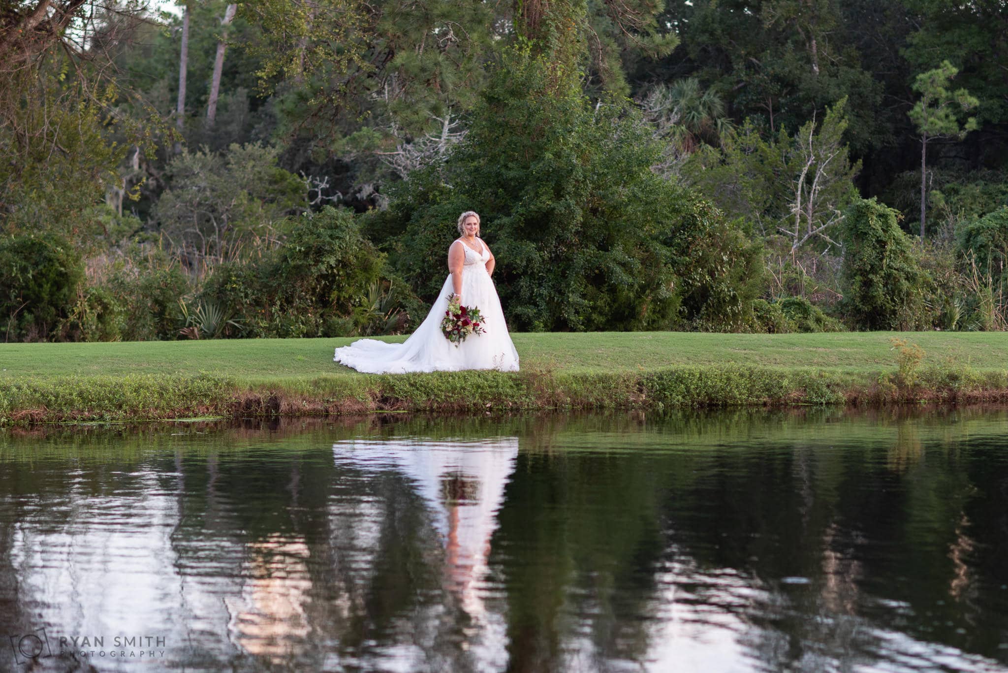 Bride reflecting in the lake Pawleys Plantation Golf & Country Club