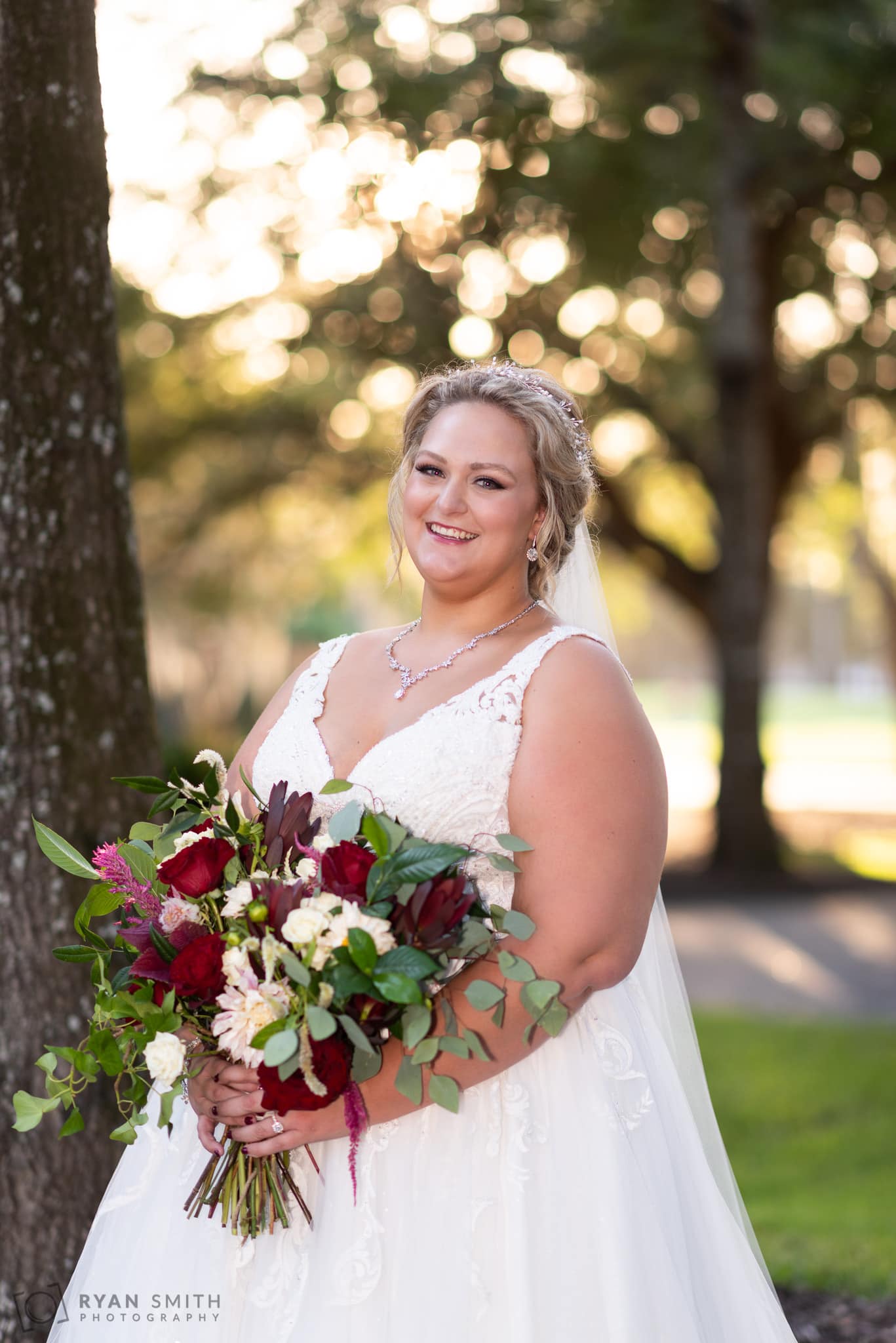 Bride smiling with out of focus light in the background Pawleys Plantation Golf & Country Club