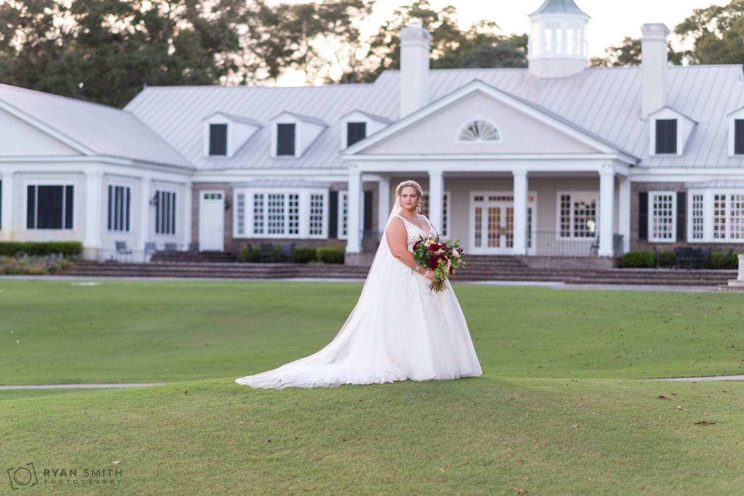 Bride standing on the golf course hill Pawleys Plantation Golf & Country Club