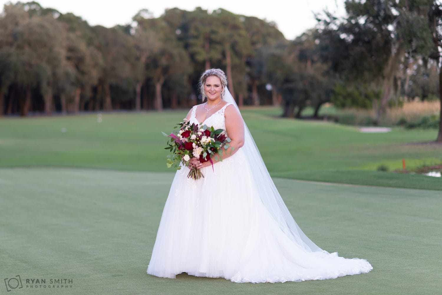 Bride standing on the golf course Pawleys Plantation Golf & Country Club